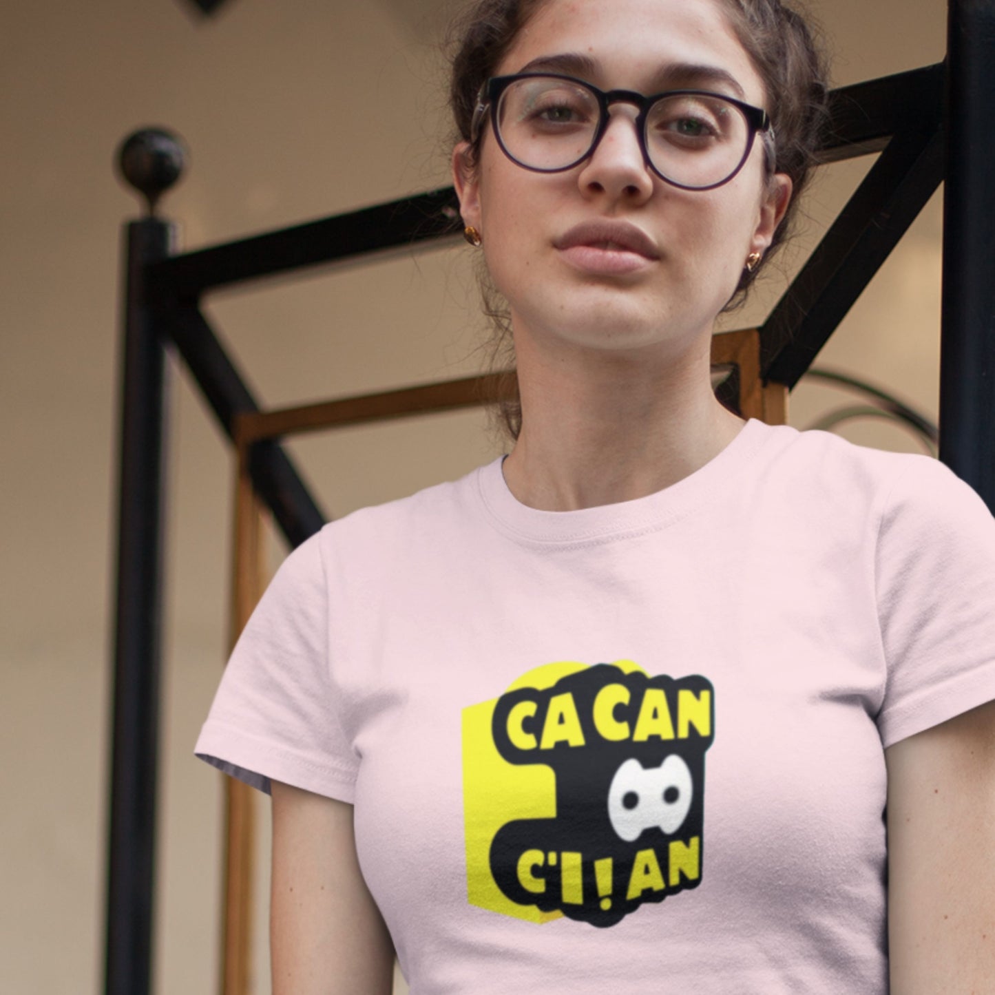 Person wearing a pink t-shirt with a graphic design and text.