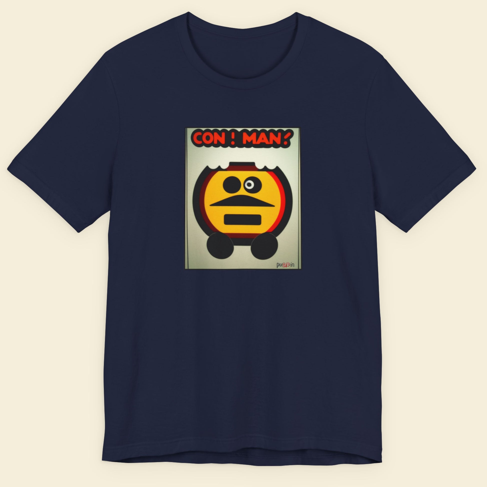Navy blue t-shirt with a graphic design of a character and 'CON MAN!' text on a beige background.