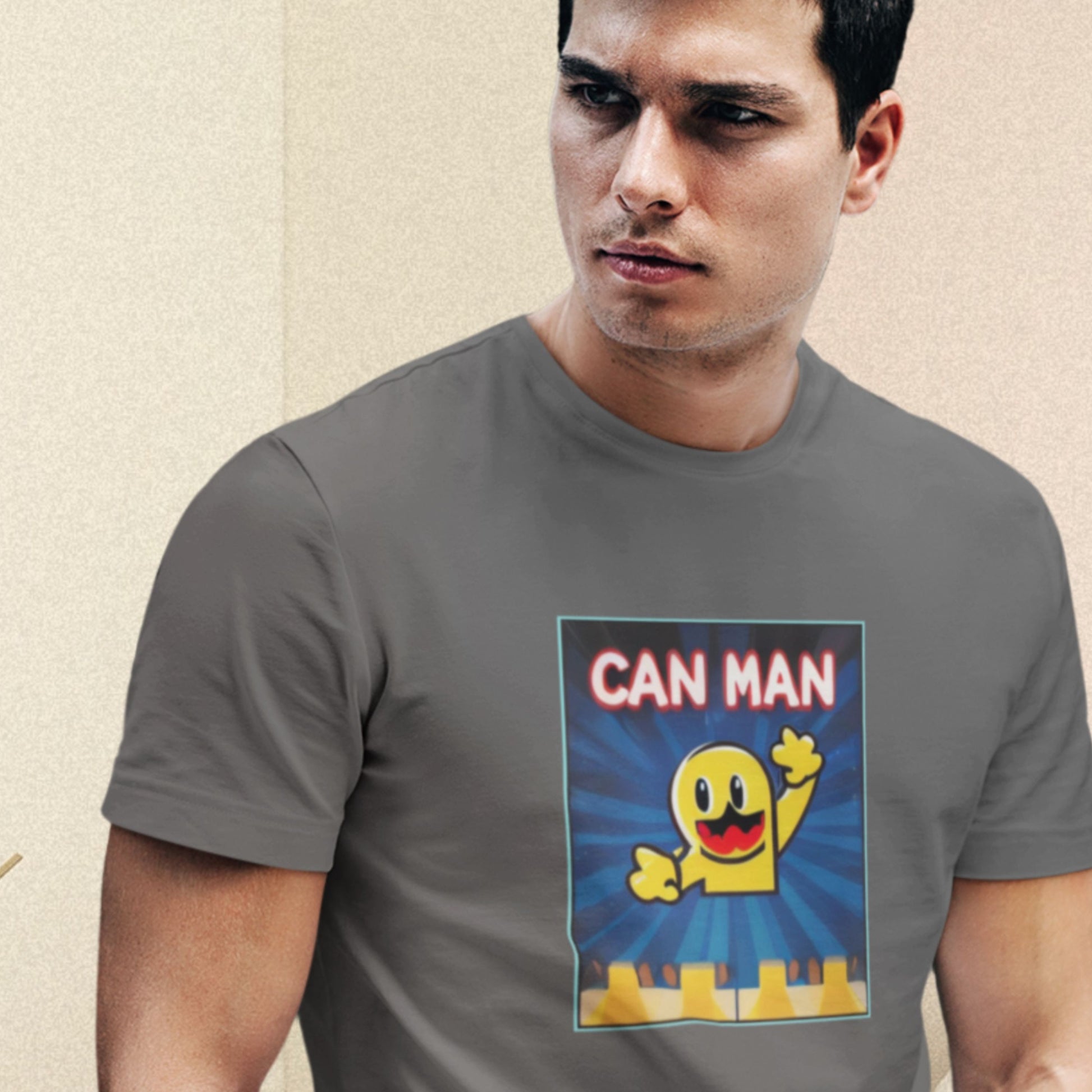 Concerned man wearing a dark grey t-shirt with a fun, colorful cartoon illustration on a beige background.