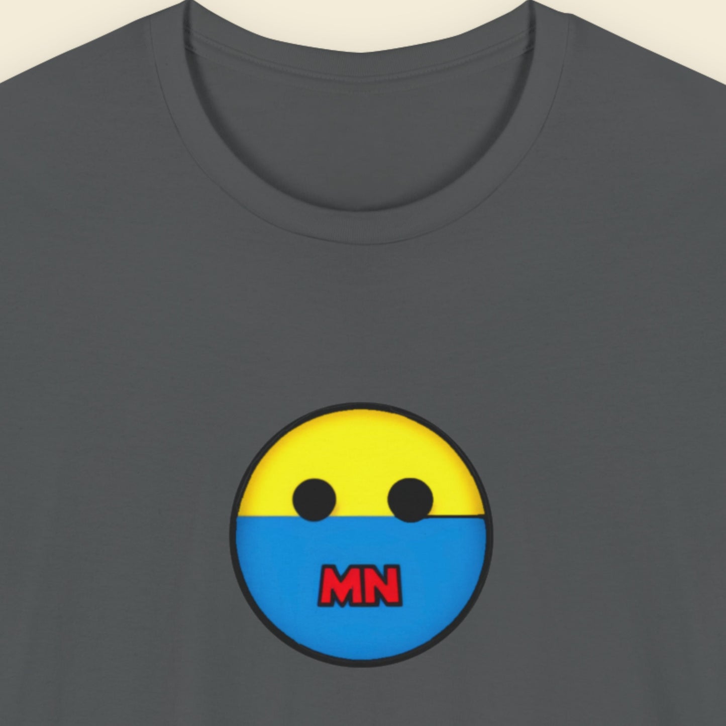 Gray t-shirt with a yellow and blue face design featuring 'MN' on a beige background.