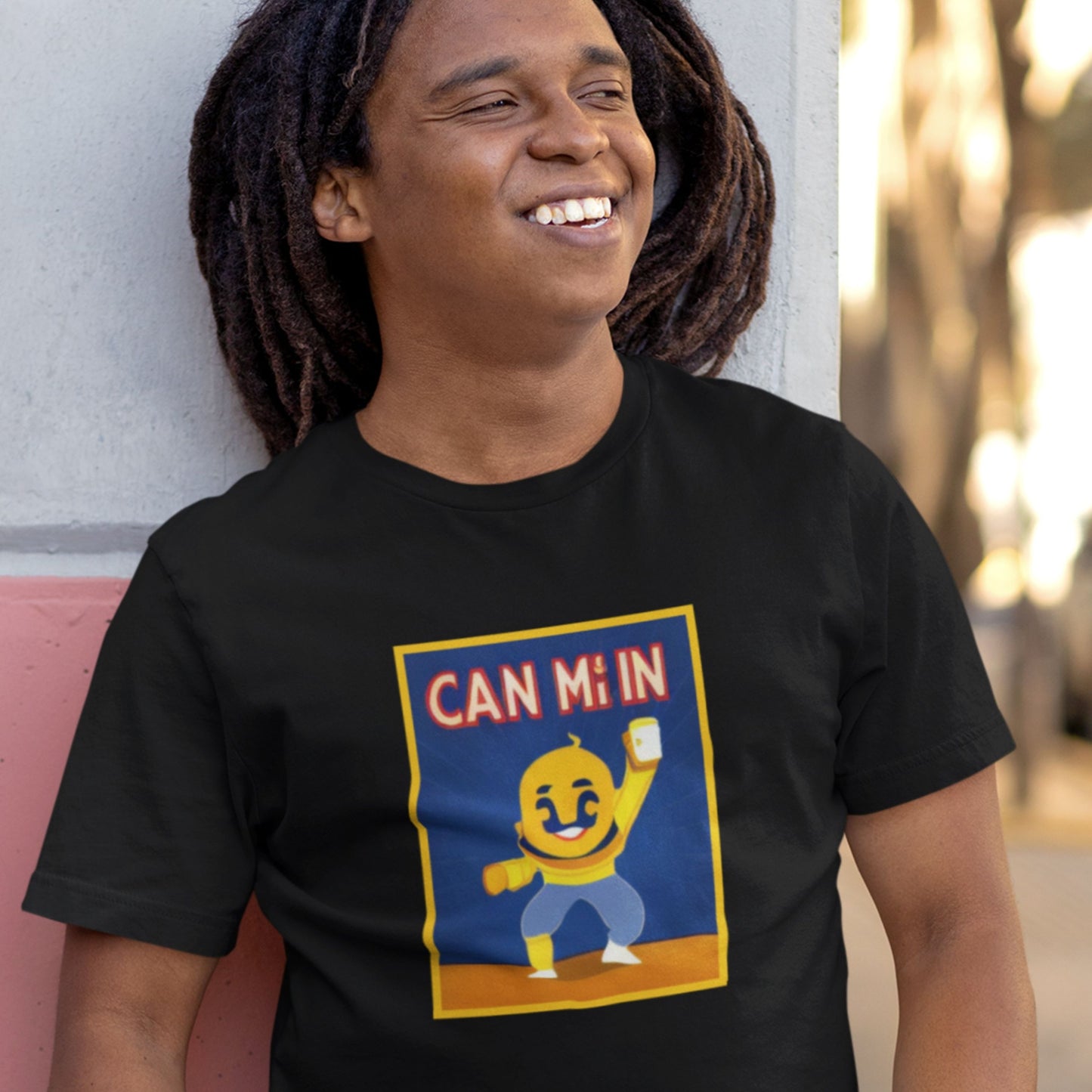 Person wearing a black t-shirt with a colorful graphic design featuring text and a character.