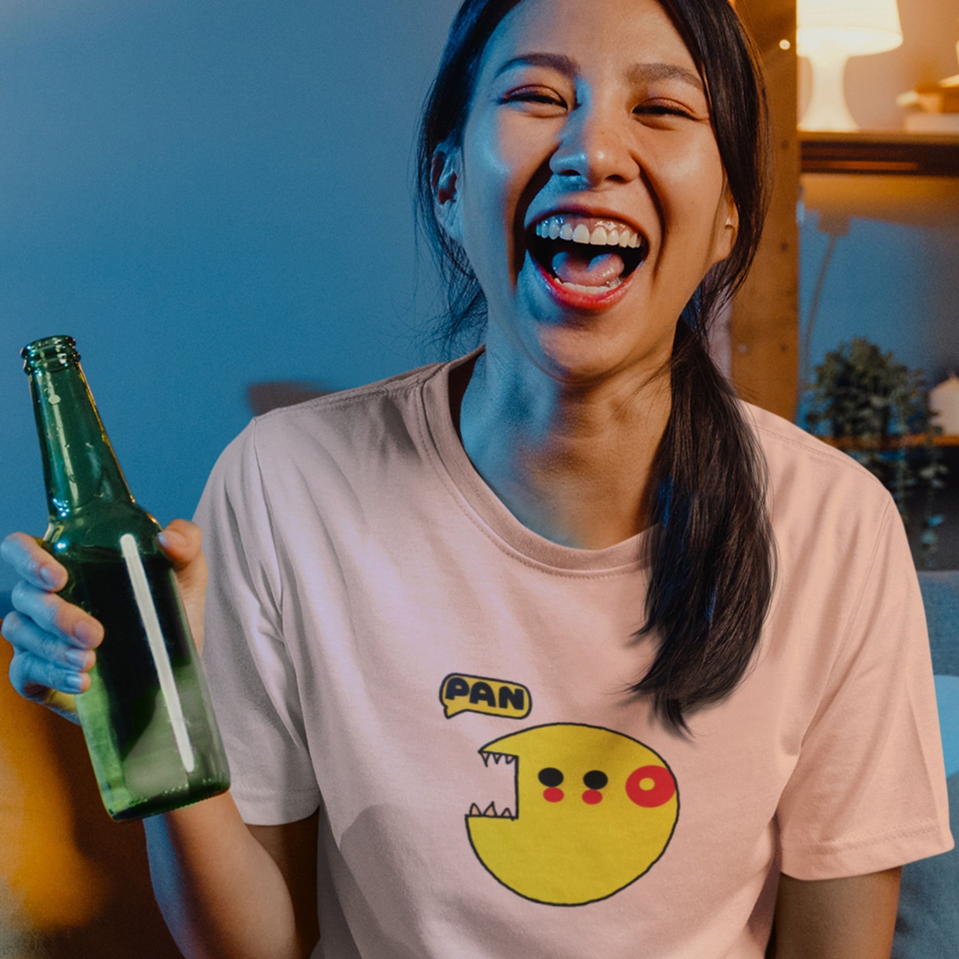 Party girl wearing a pink t-shirt with a smiley face design, holding a green bottle.