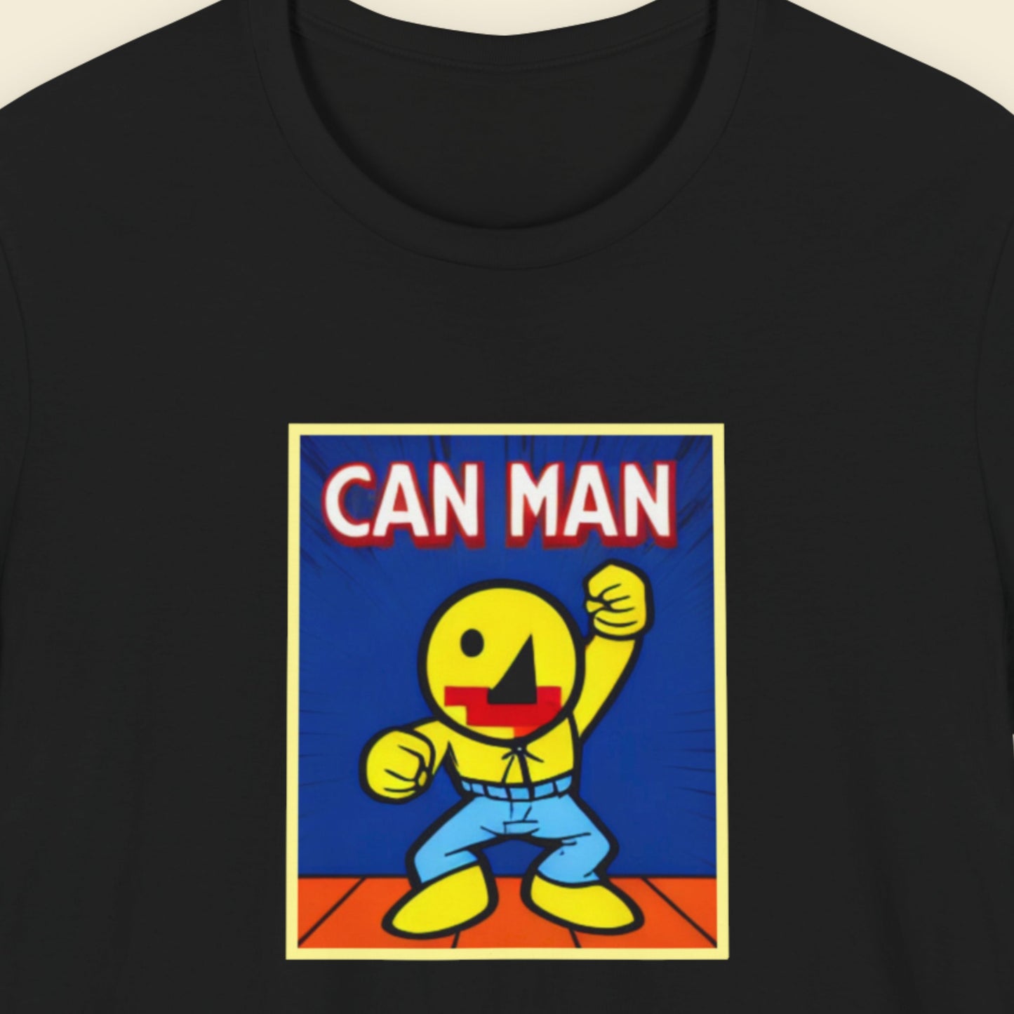 Black t-shirt with a graphic of a yellow character labeled 'CAN MAN' on a blue background.