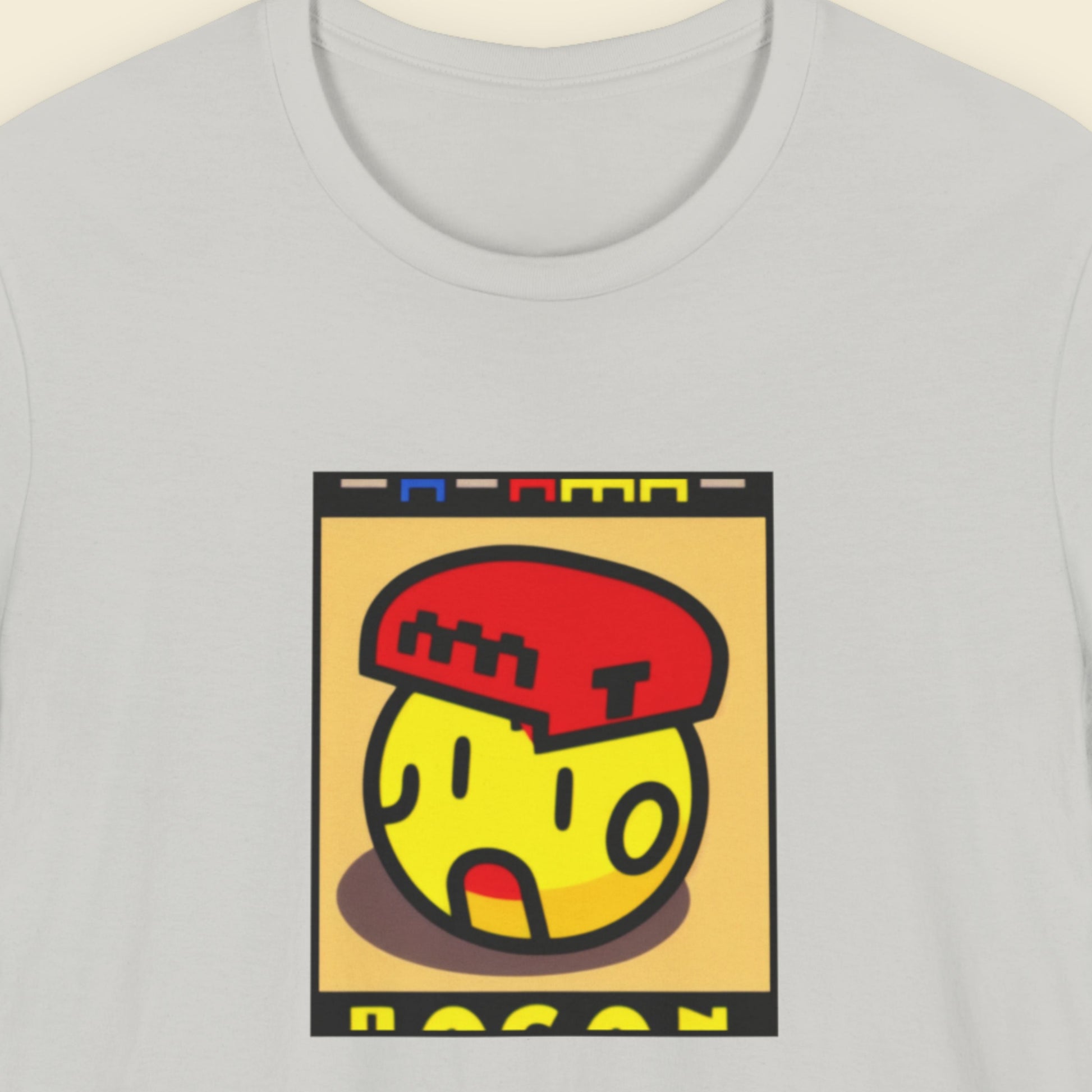Gray t-shirt with a colorful graphic design on a beige background.
