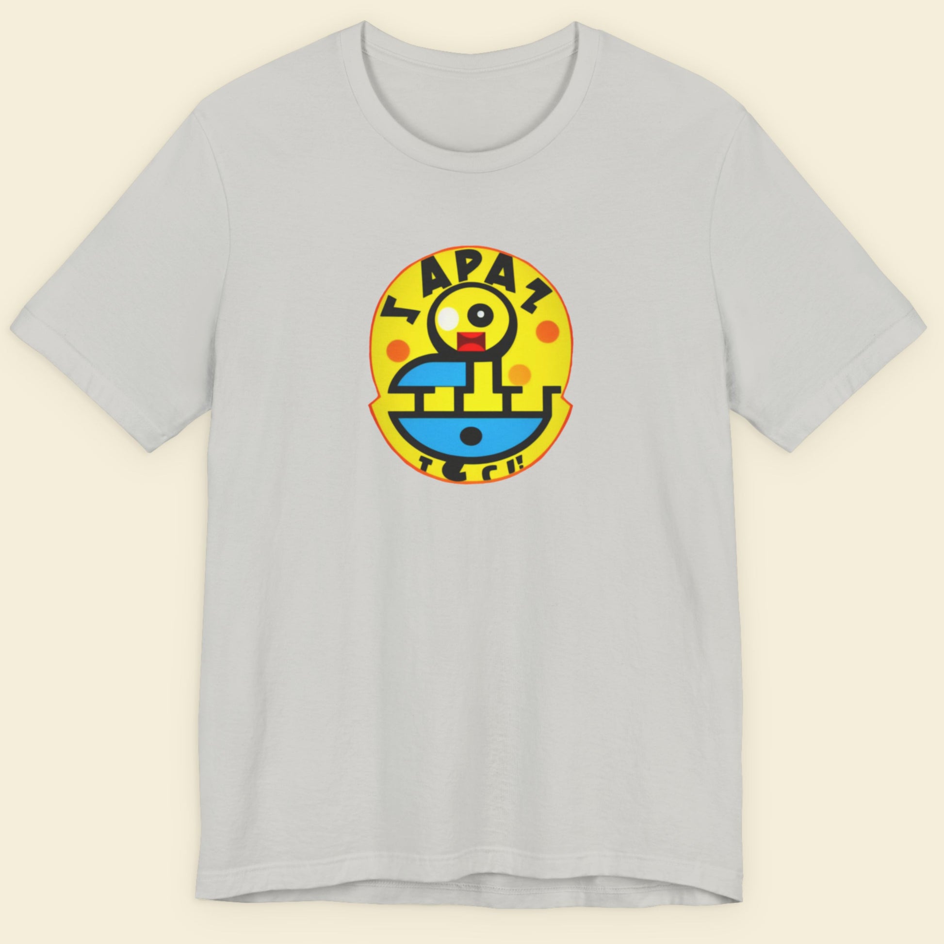 Grey t-shirt with a fun, colorful nonsense cartoon illustration on a beige background.