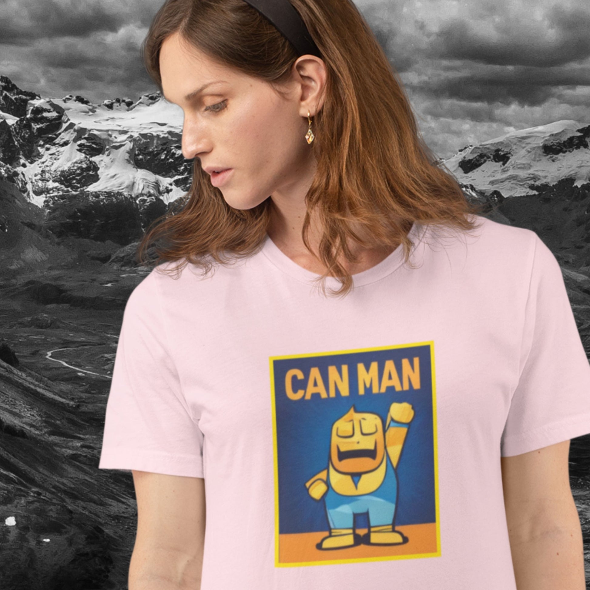 Woman wearing a pink t-shirt with a colorful cartoon illustration in the mountains. 