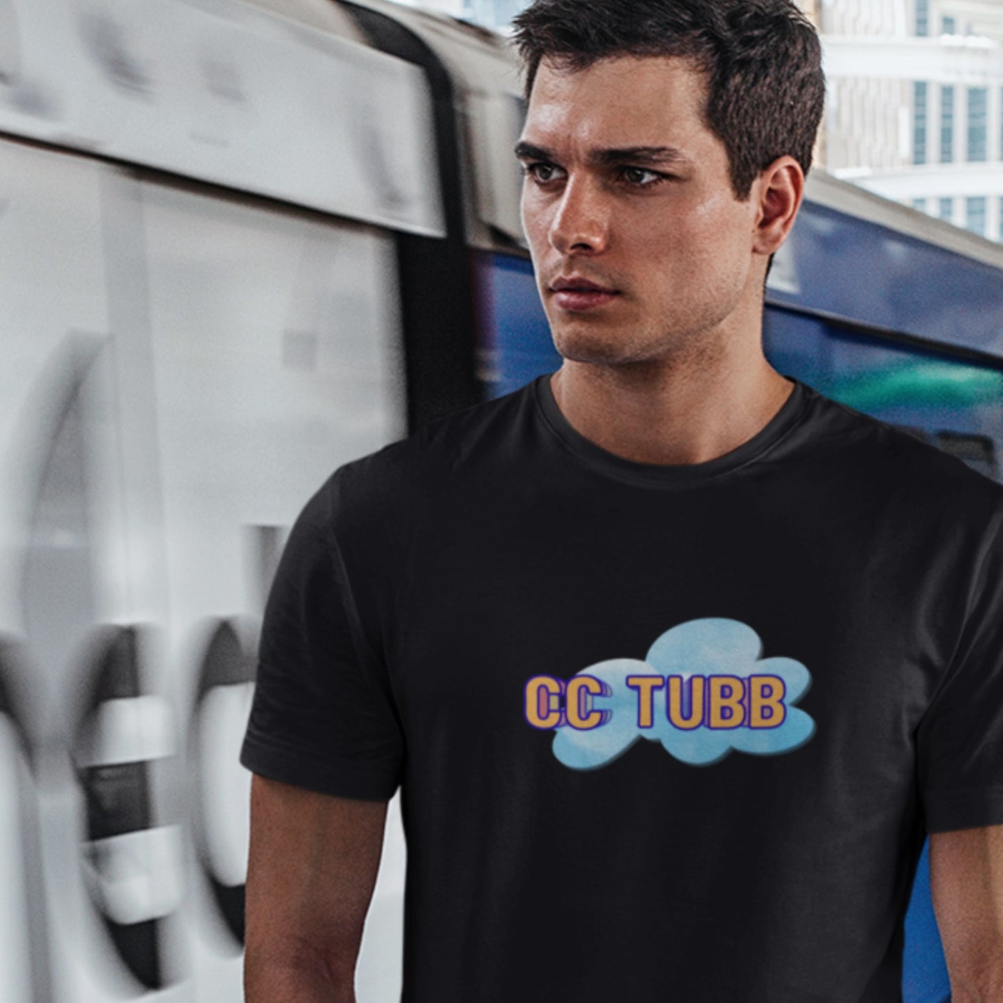 Man wearing a black t-shirt with 'CC TUBB' design in an urban setting.