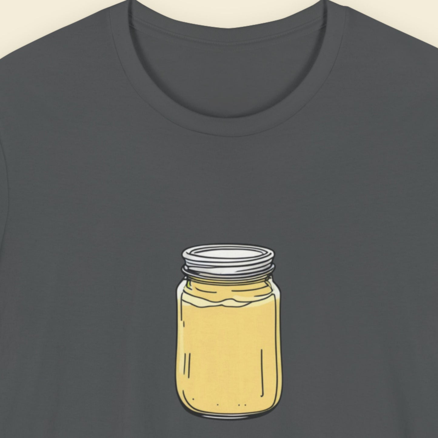 Dark gray t-shirt with a yellow jar graphic on a beige background.