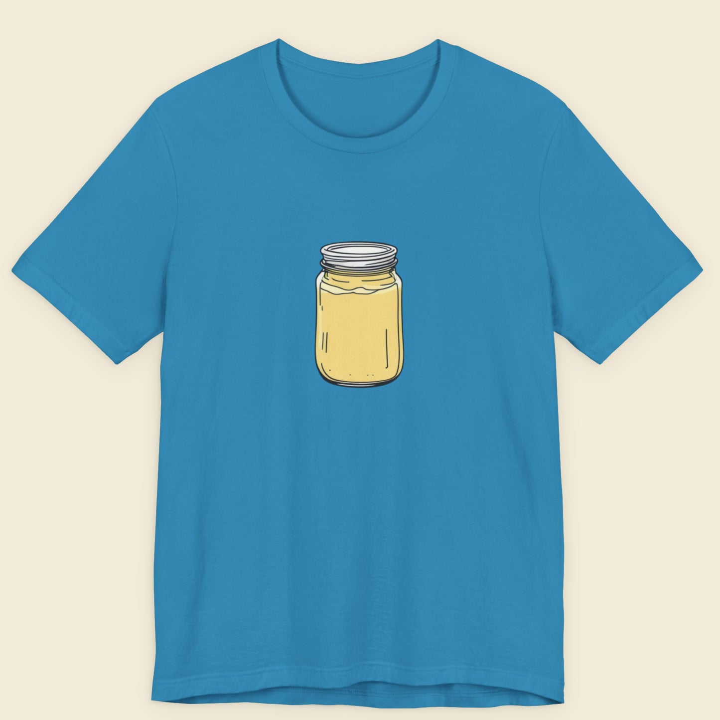 Blue t-shirt with a jar graphic on a beige background.