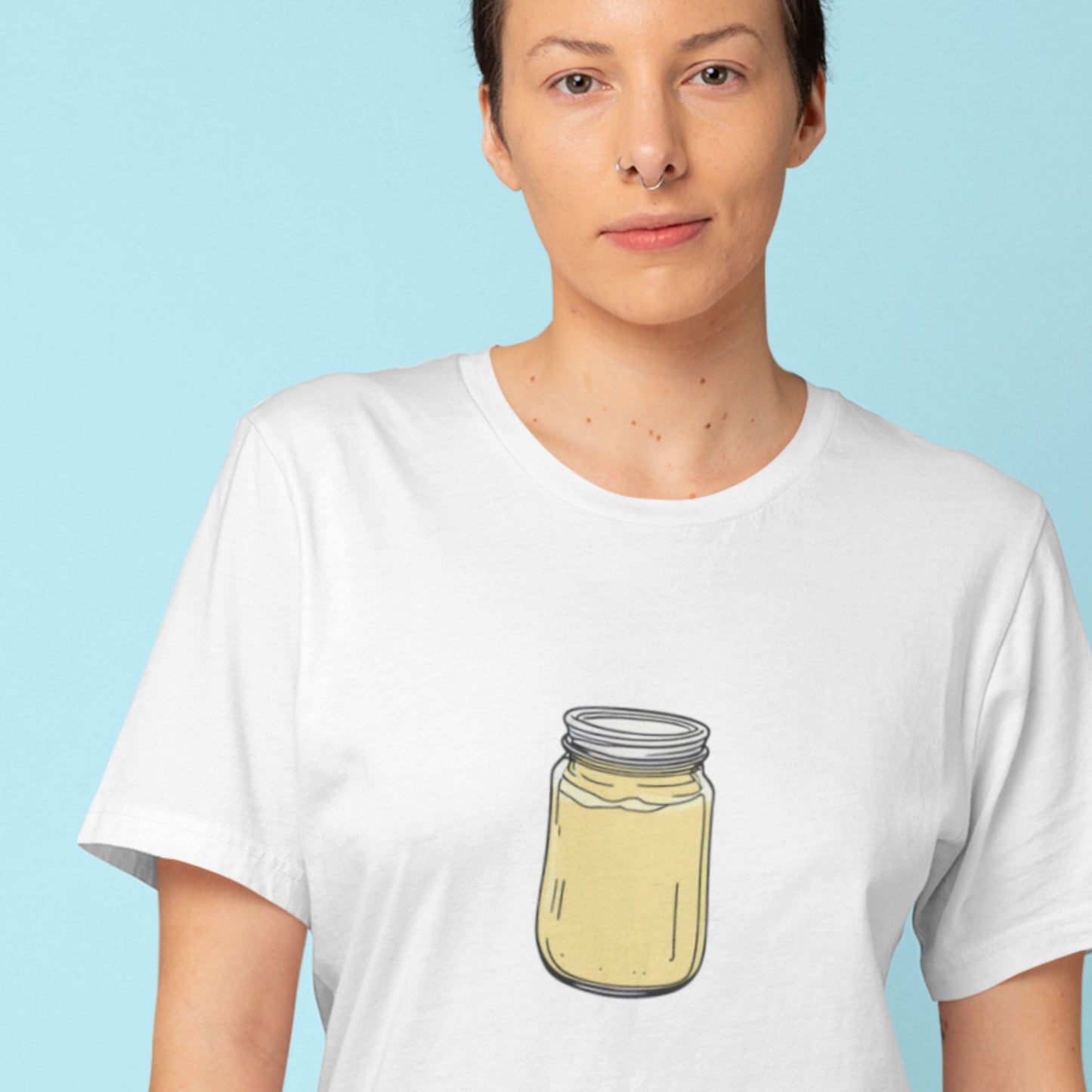 Person wearing a white t-shirt with a jar graphic on a light blue background.