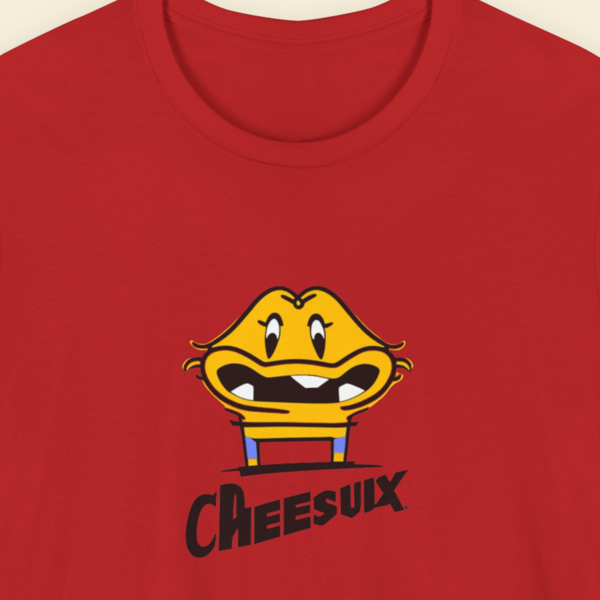 Red t-shirt with a fun, colorful cartoon illustration on a beige background.