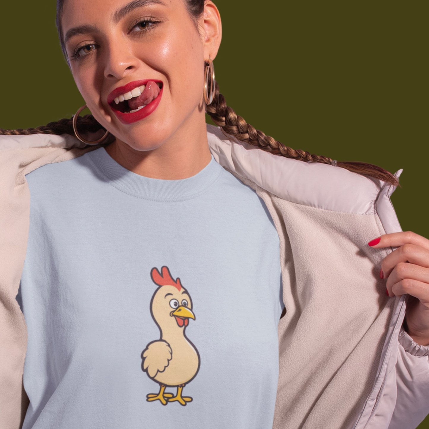 Woman wearing a light blue tee with a cartoon illustration of a chicken.