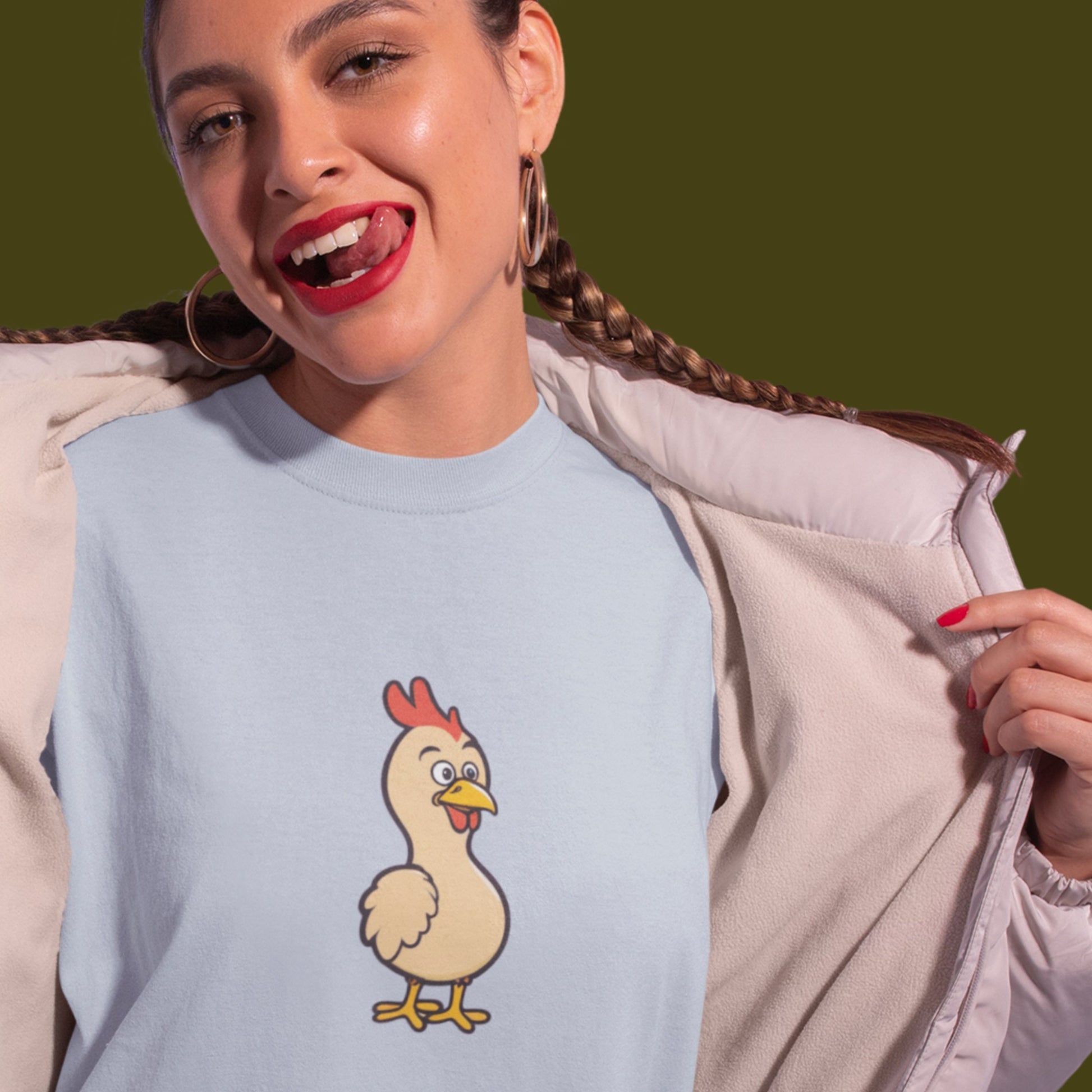Woman wearing a light blue tee with a cartoon illustration of a chicken.