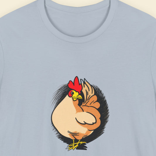 Light blue shirt with a colorful rooster illustration on a beige background.