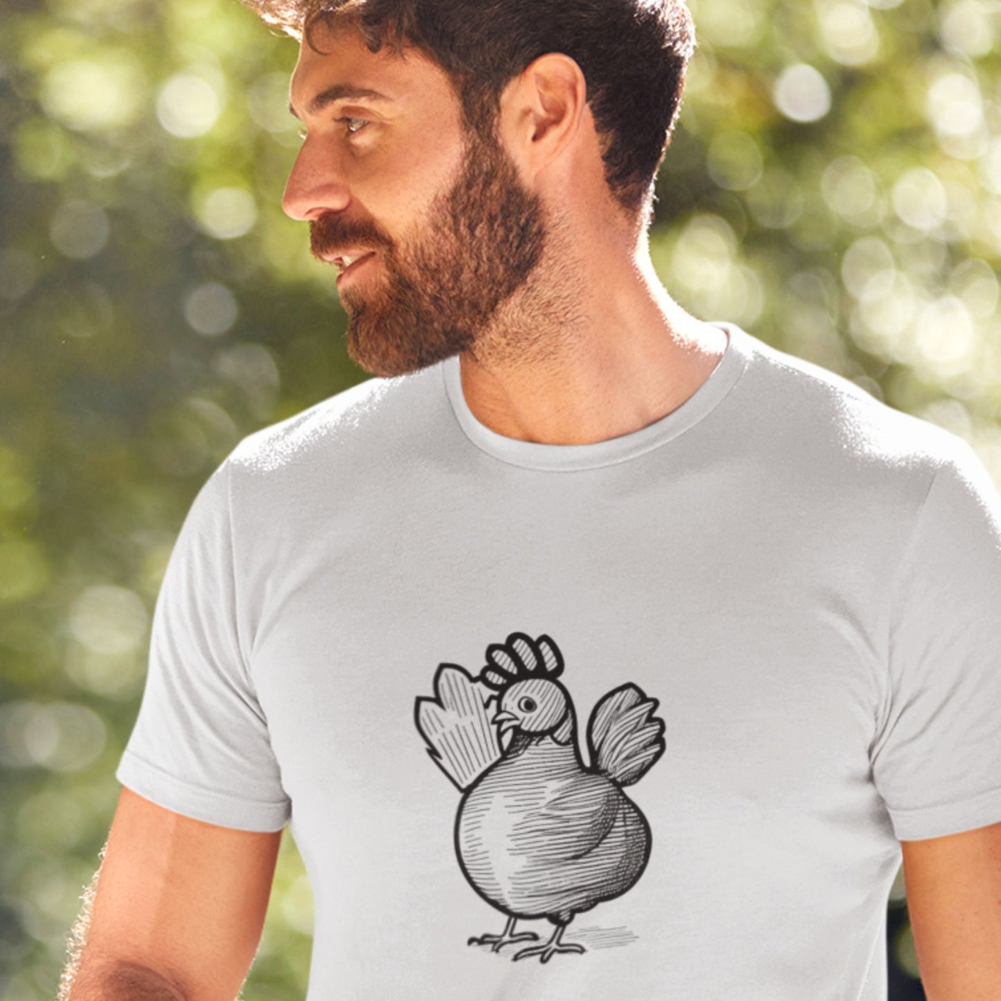Man wearing a light gray t-shirt with a chicken graphic outdoors
