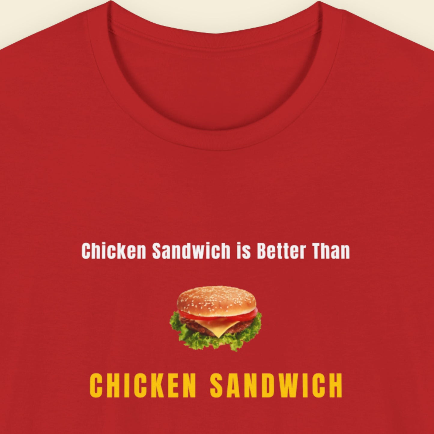 Red t-shirt with humorous colorful text and chicken sandwich picture  on a beige background.