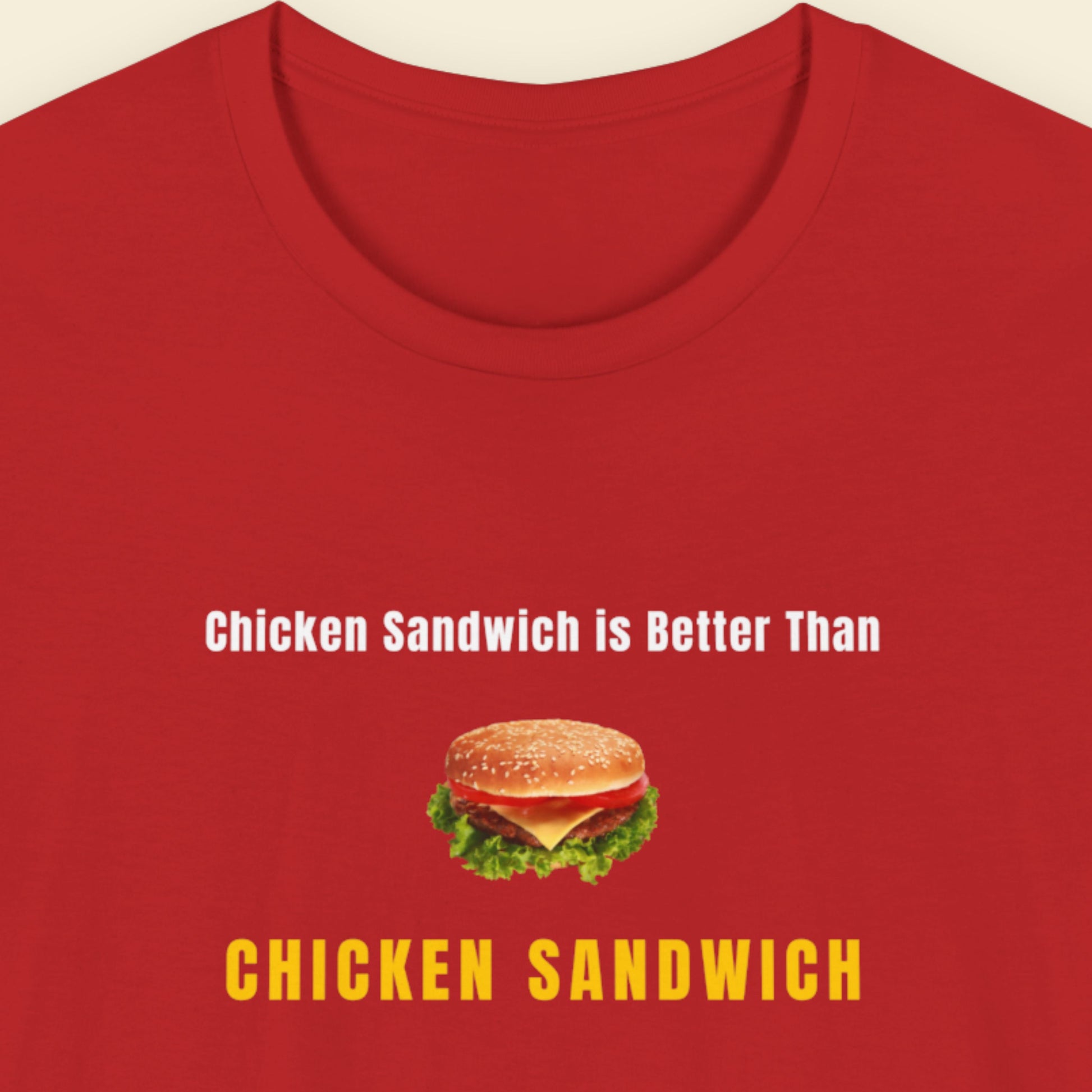 Red t-shirt with humorous colorful text and chicken sandwich picture  on a beige background.