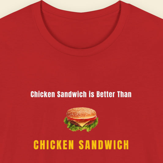 Red t-shirt with humorous colorful text and chicken sandwich picture  on a beige background.