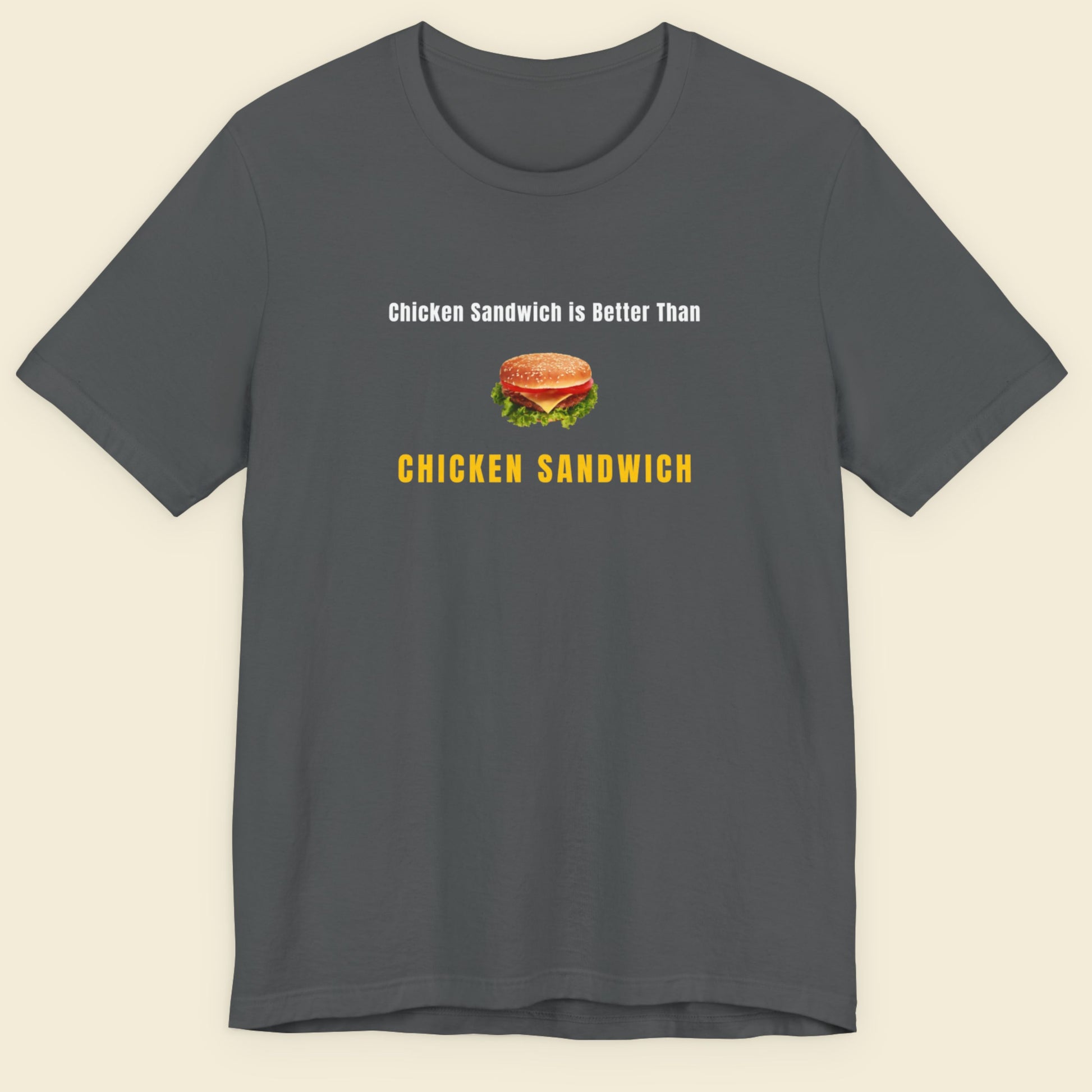 Gray t-shirt with a graphic and text about chicken sandwiches on a beige background.