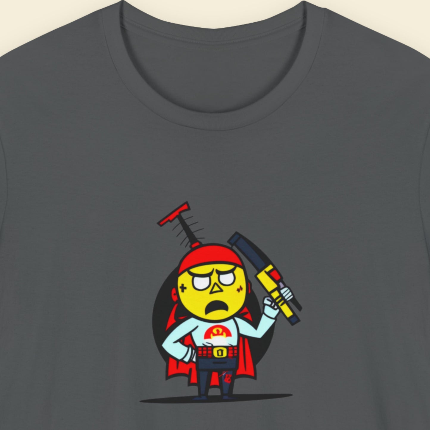 Grey t-shirt with a fun, cartoon illustration on a beige background.