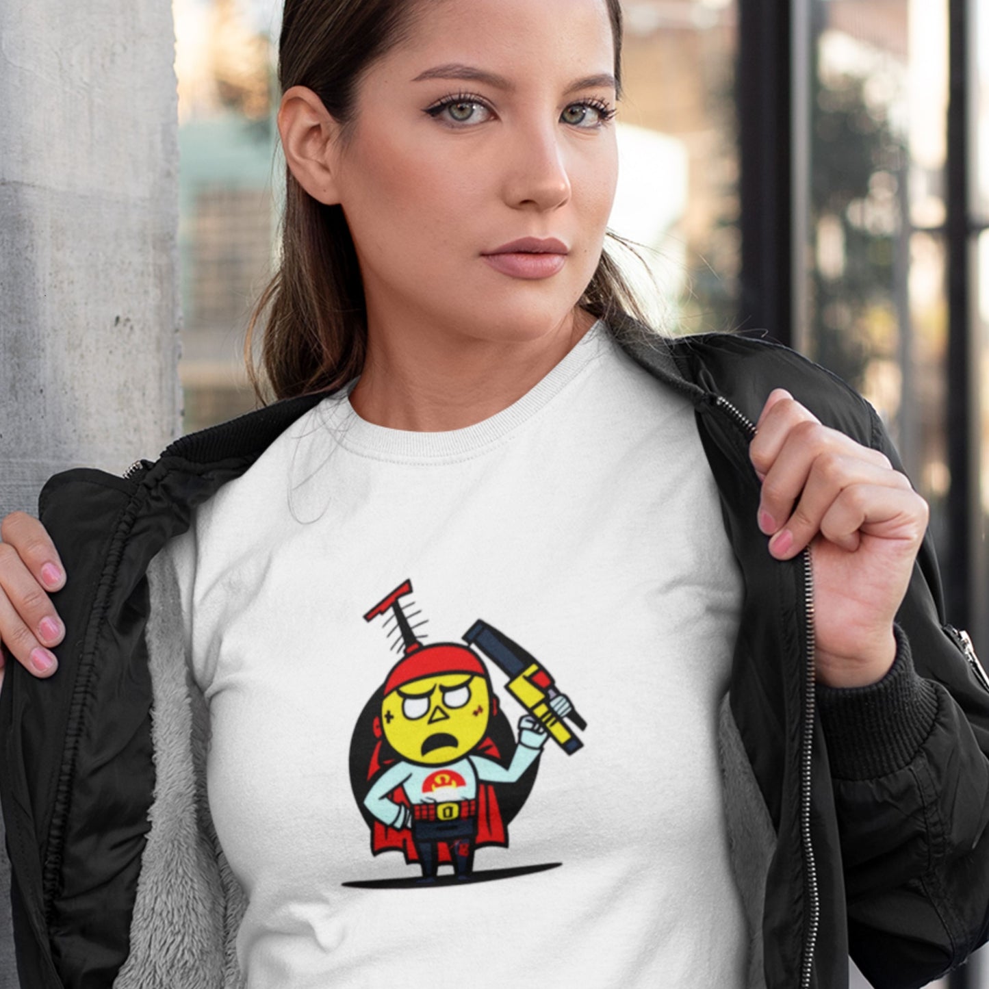 Woman wearing a white t-shirt with a fun, cartoon illustration outside.