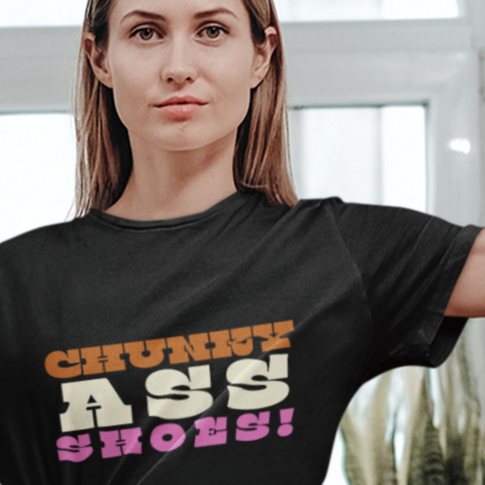 Person wearing a black t-shirt with colorful text design.