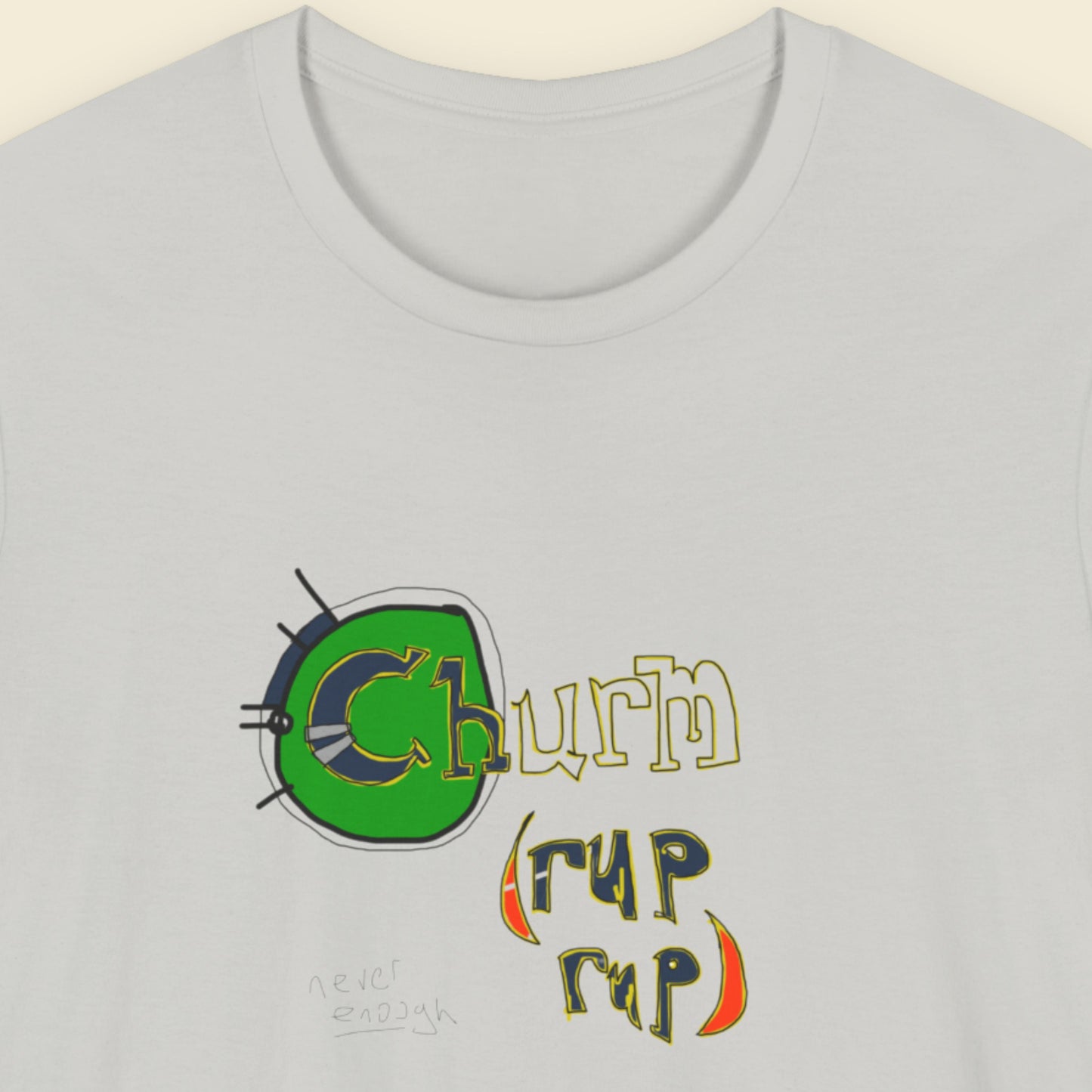 Grey t-shirt with a colorful abstract trash graff drawing on a beige background.