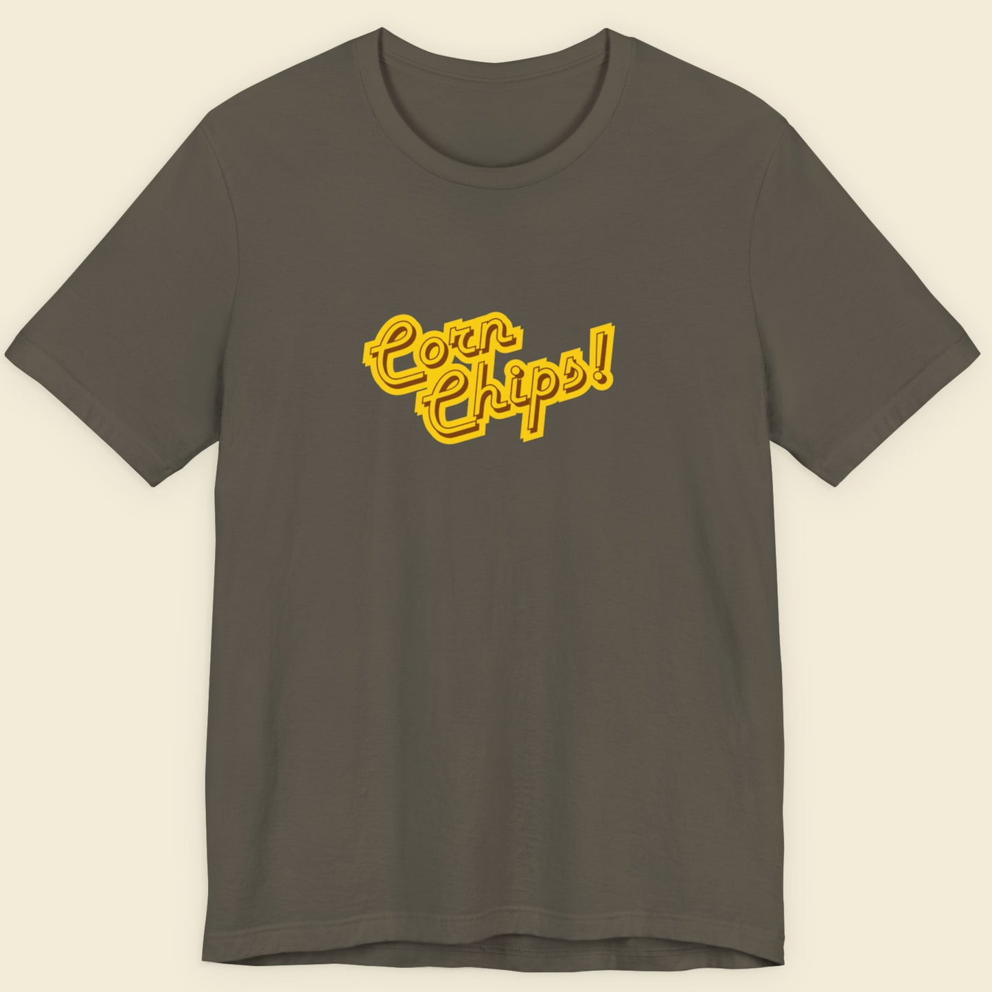 Army green t-shirt with multicolored 'Corn Chips!' text on a beige background.