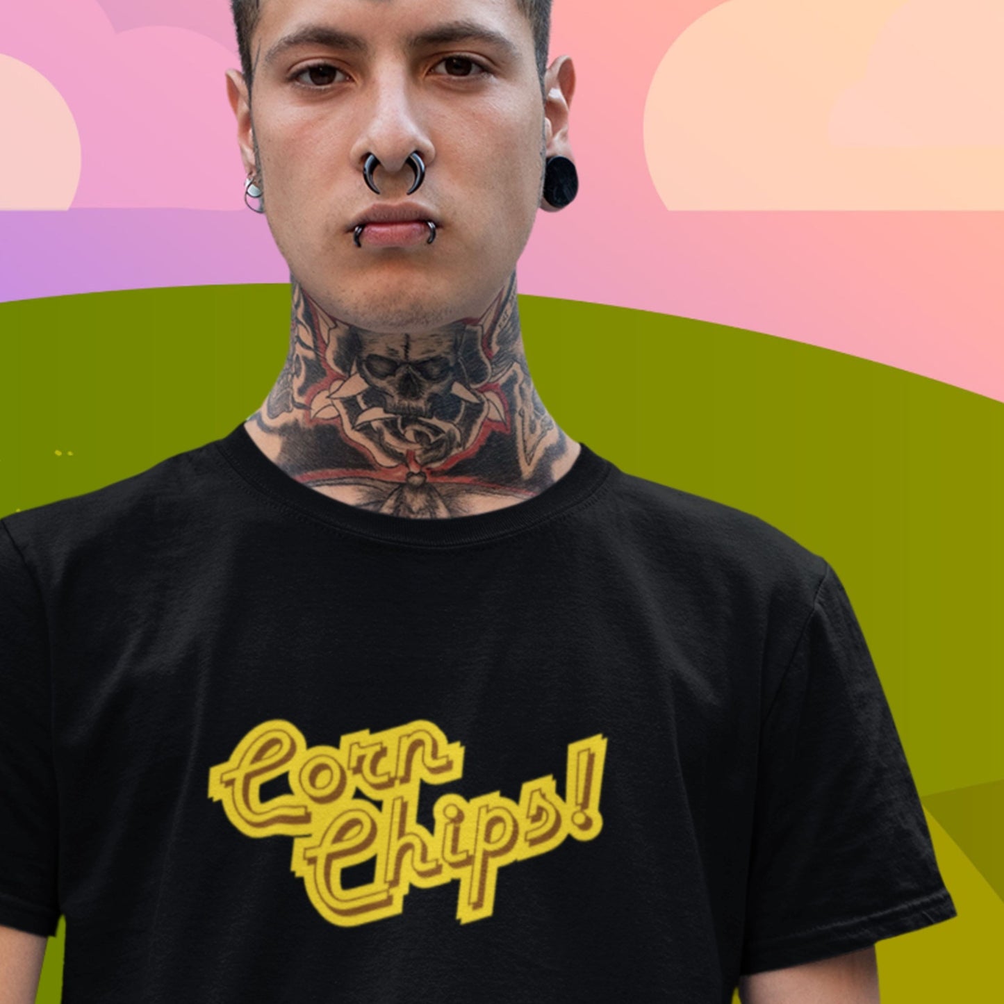 Tattoo guy wearing a black t-shirt with multicolored 'Corn Chips!' text on a colorful background.