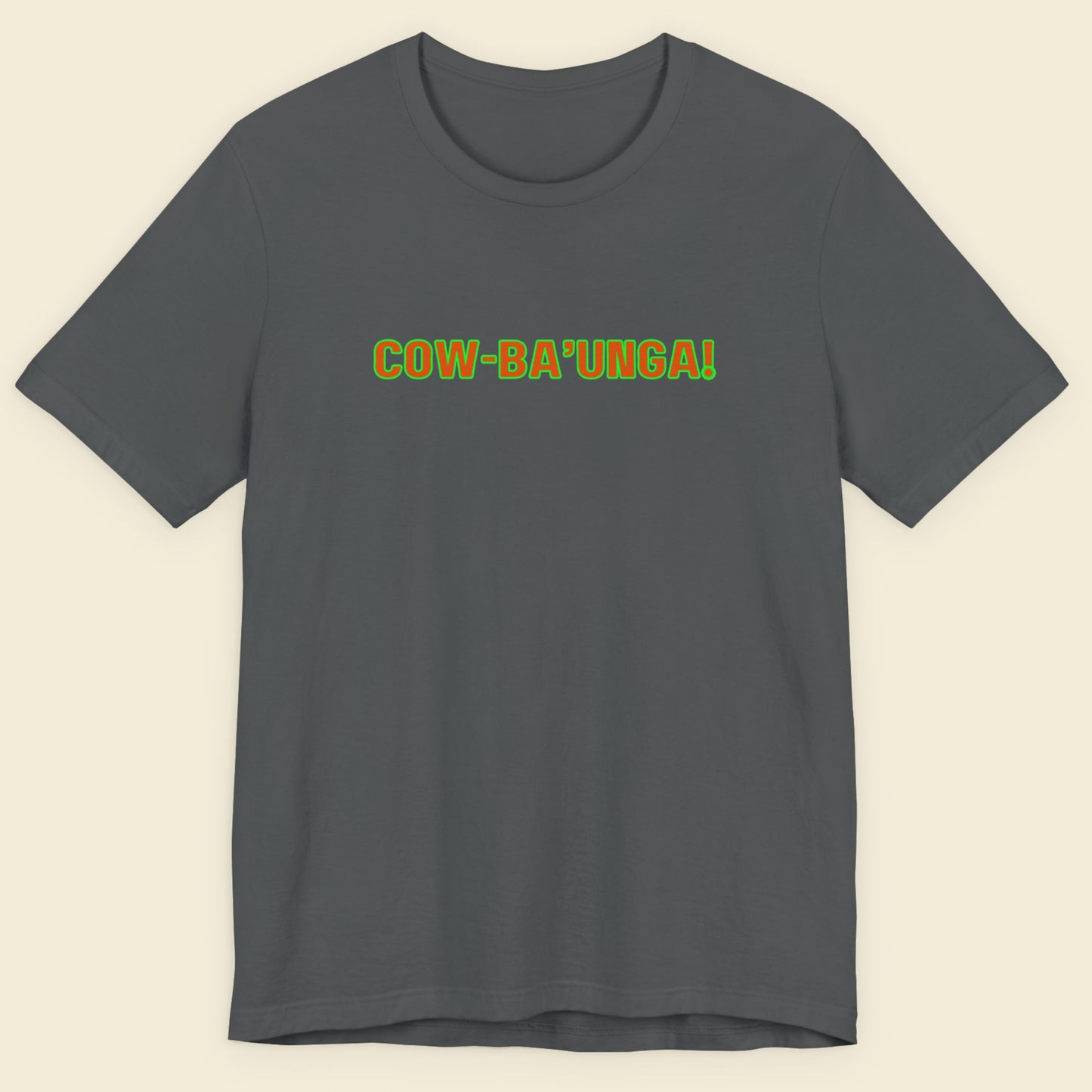 Grey t-shirt with humorous colorful text on a beige background.