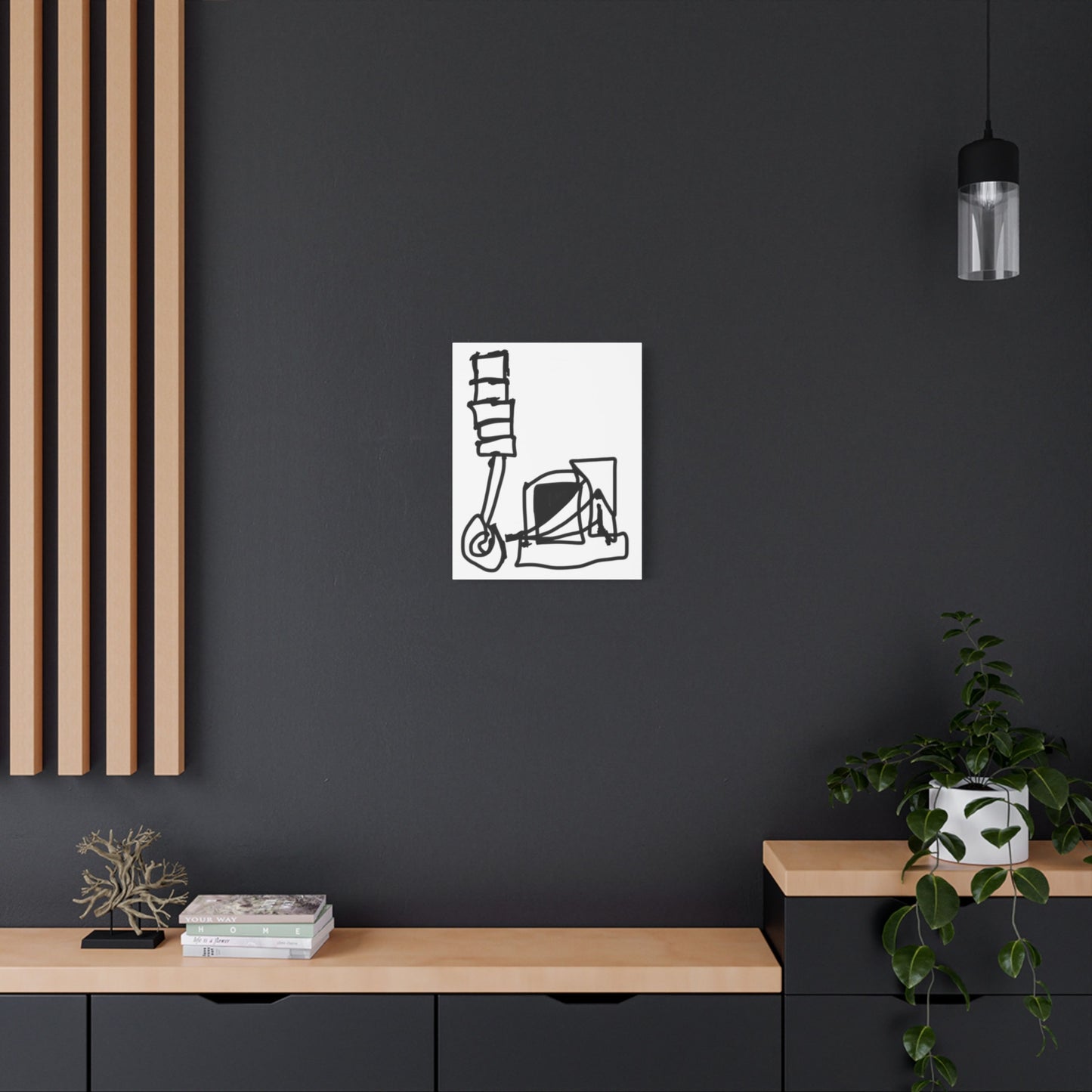 Minimalist black and white abstract art on a dark wall with wooden shelves and decor.