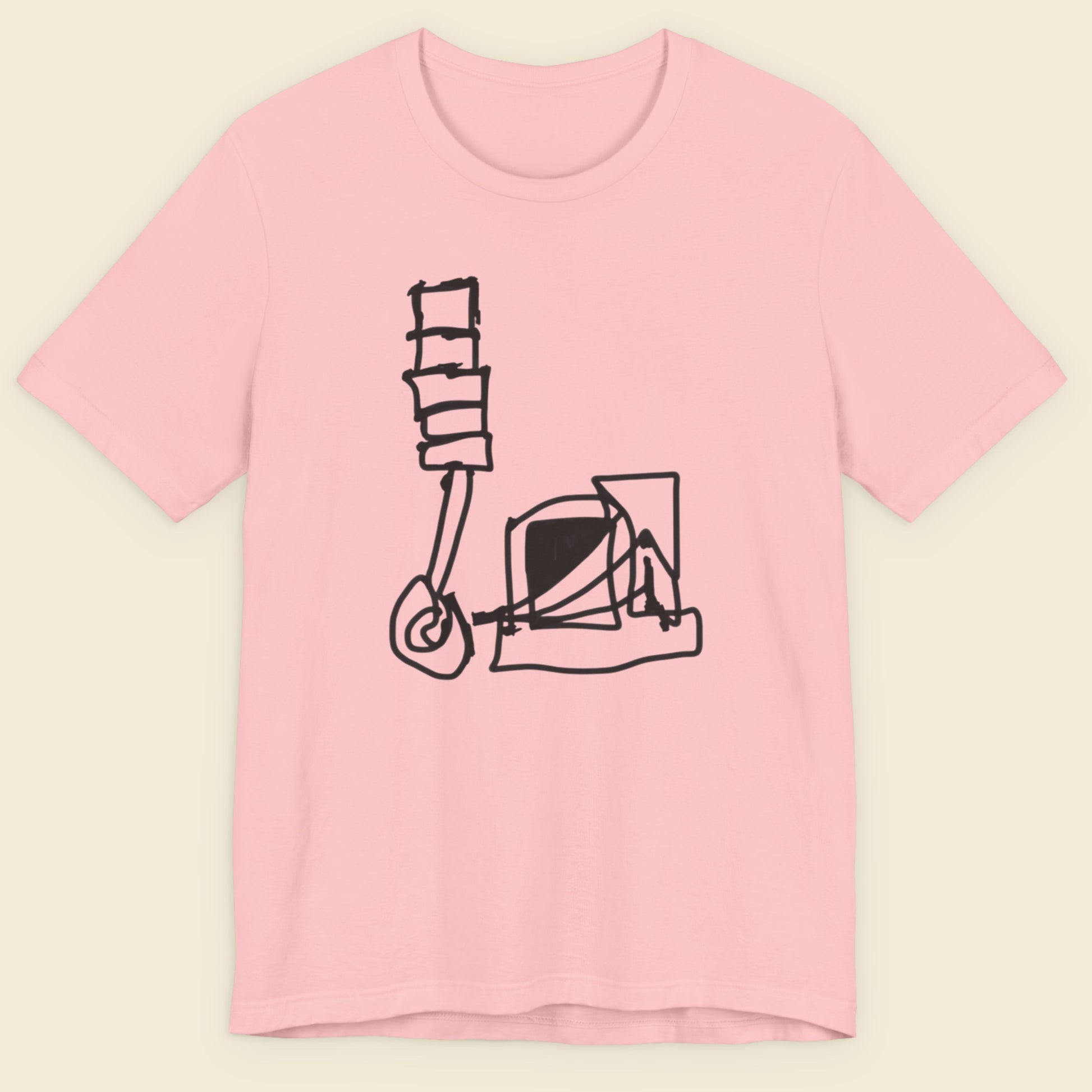 Pink t-shirt with a black graphic design on a beige background.