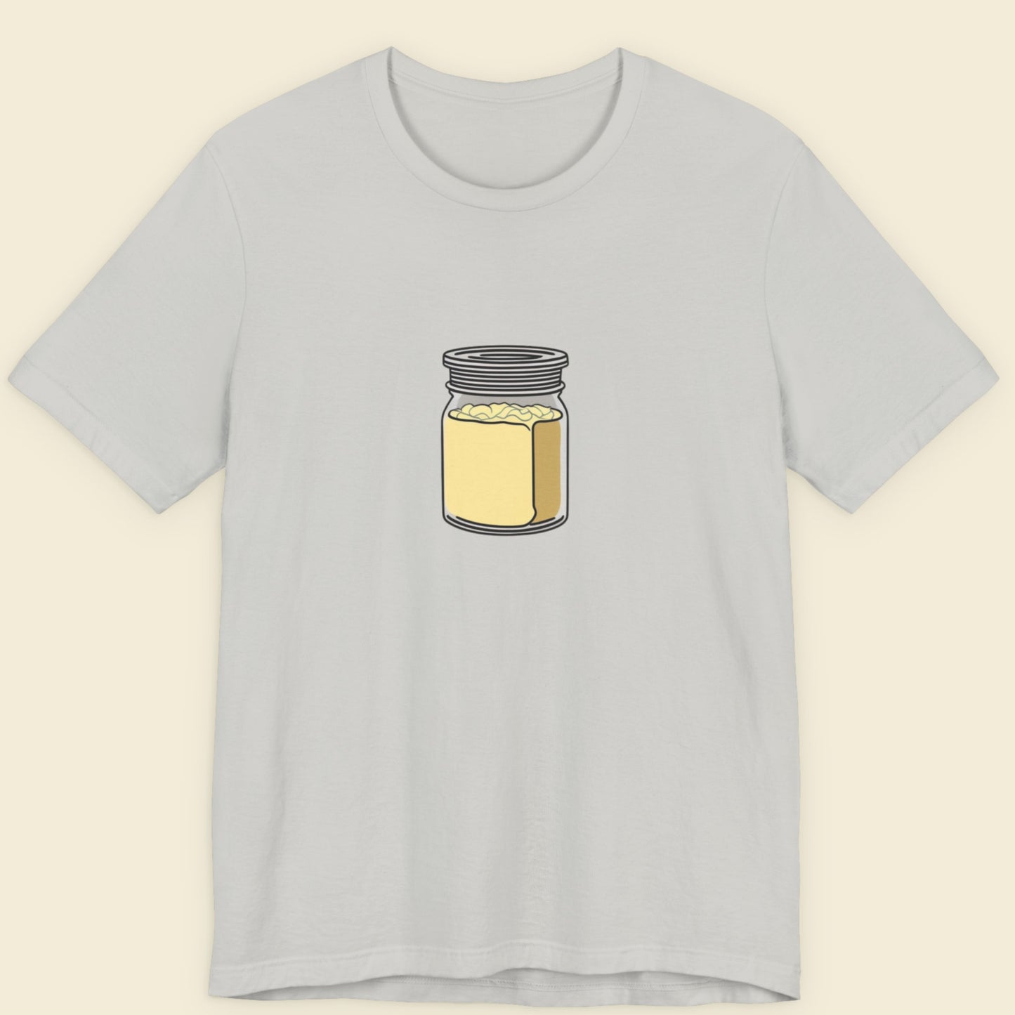 Gray t-shirt with a jar of creamy mayo graphic on a beige background