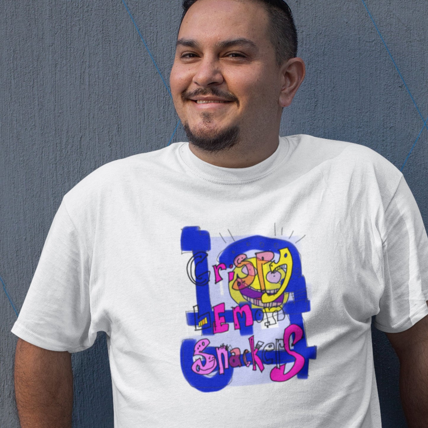 Man wearing a white t-shirt with a colorful abstract trash graff drawing on a grey background.