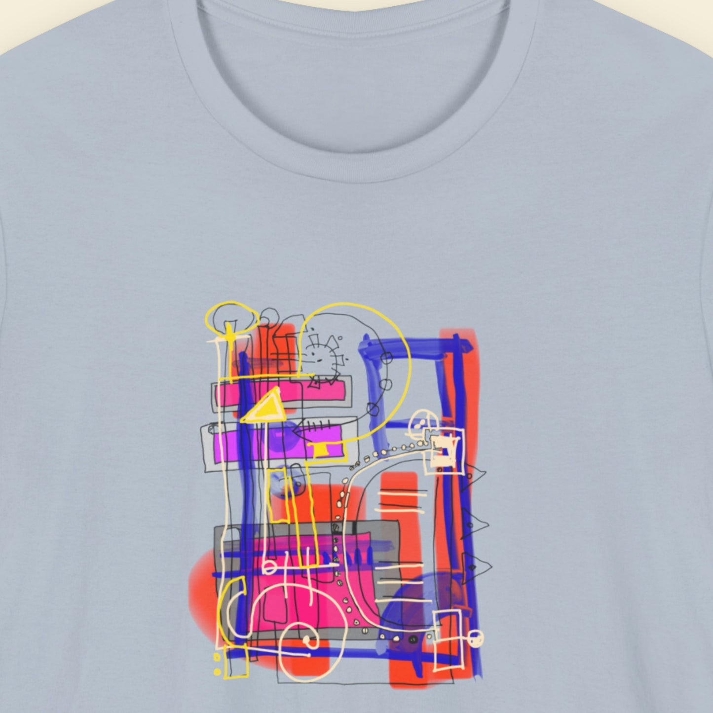 Blue t-shirt with a colorful drawing on a beige background.