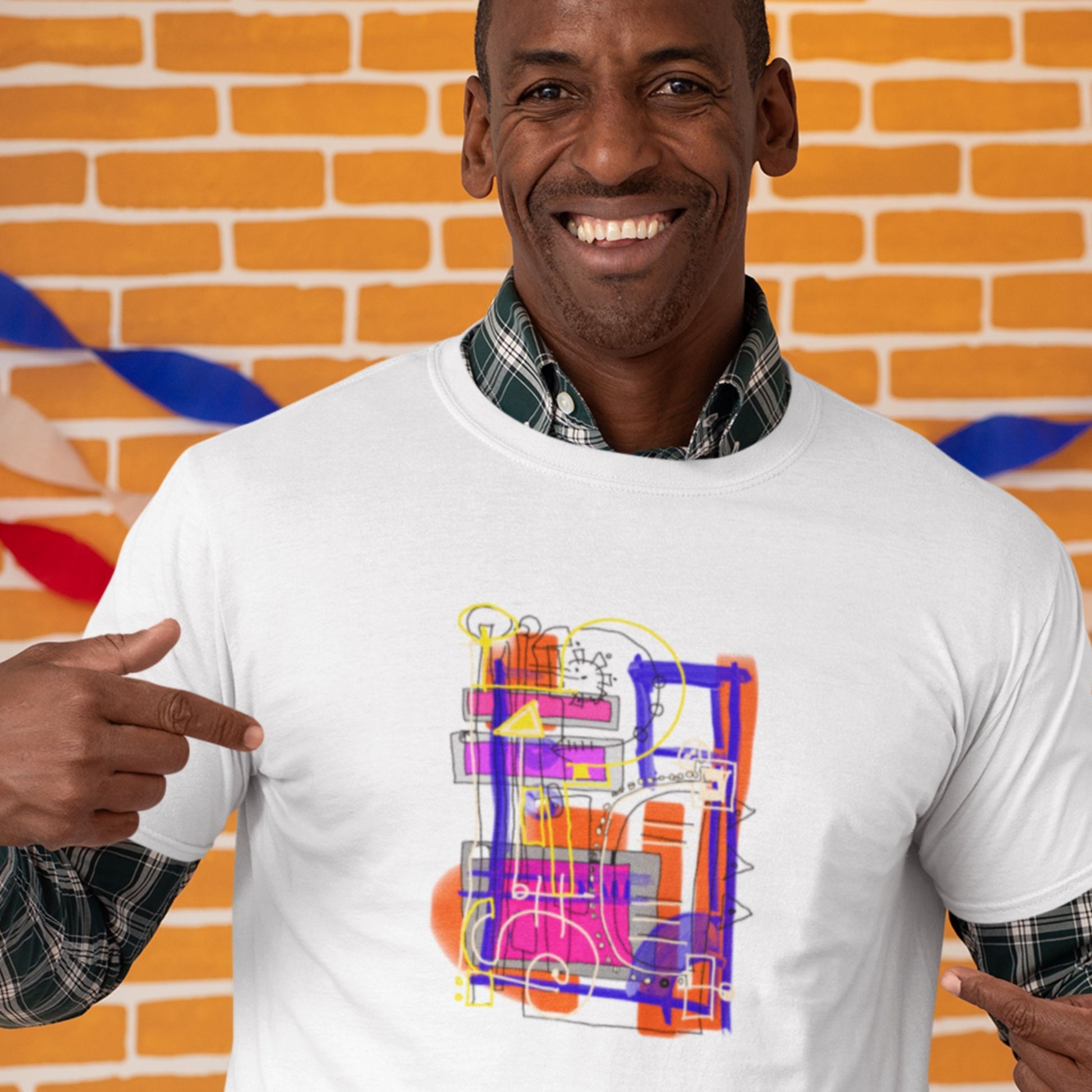 Pointing man wearing a white t-shirt with a colorful drawing in a school.