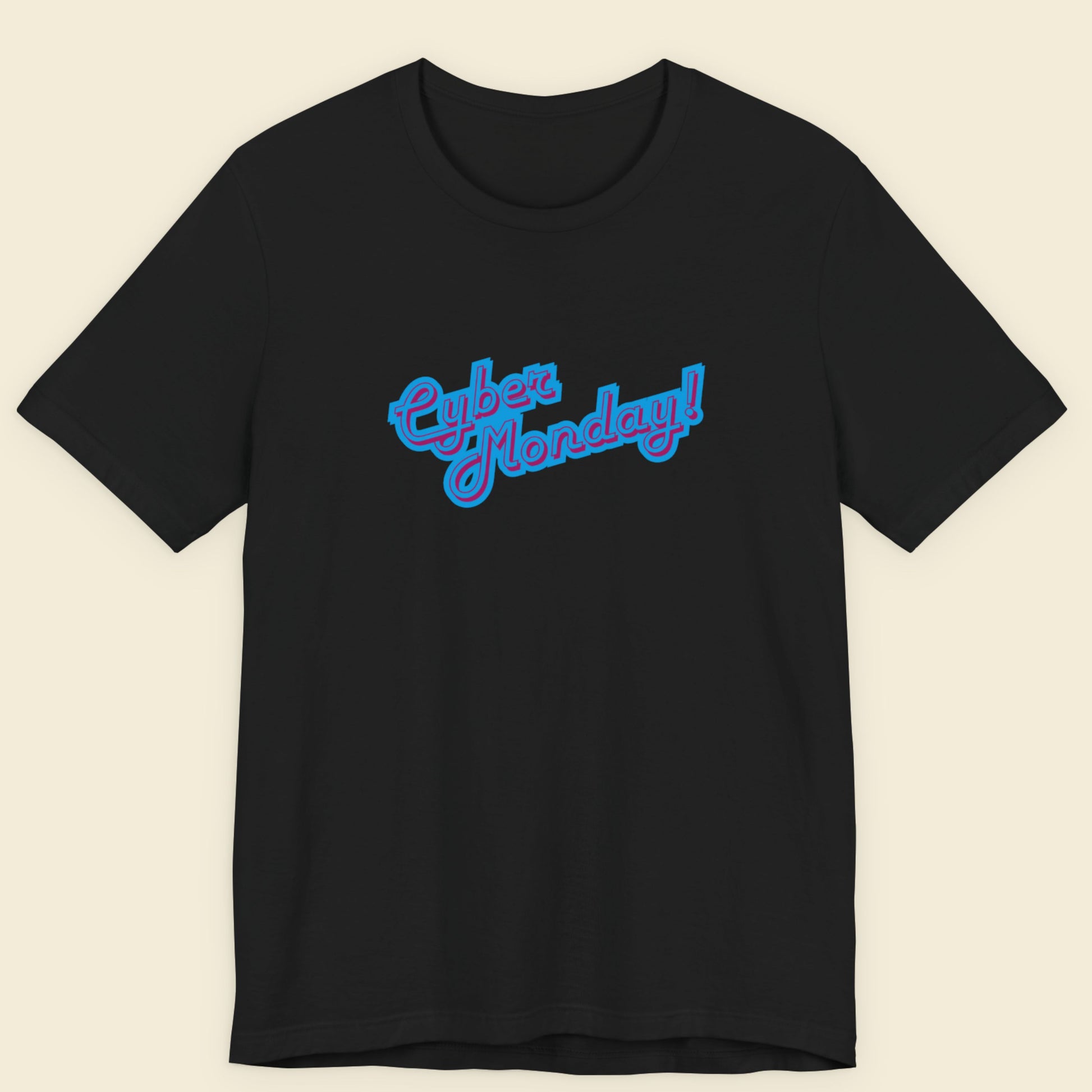 Black t-shirt with multicolored 'Cyber Monday!' text on a beige background.