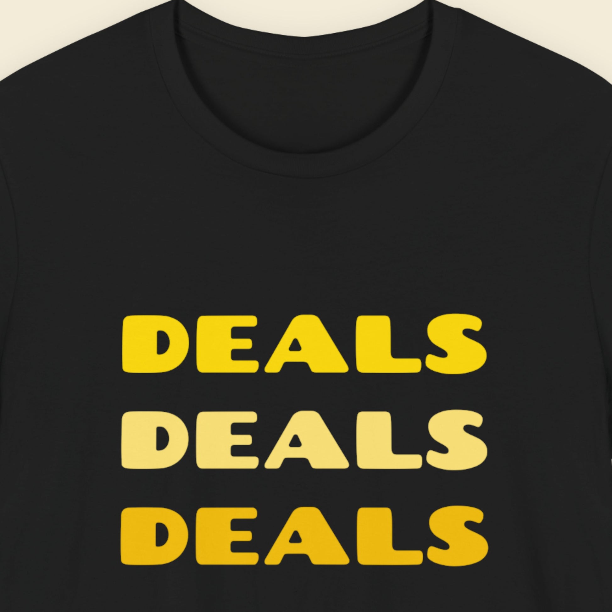 Black t-shirt with 'DEALS DEALS DEALS' text in yellow on a beige background.