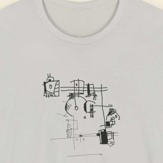 Grey t-shirt with an abstract line drawing on a beige background.