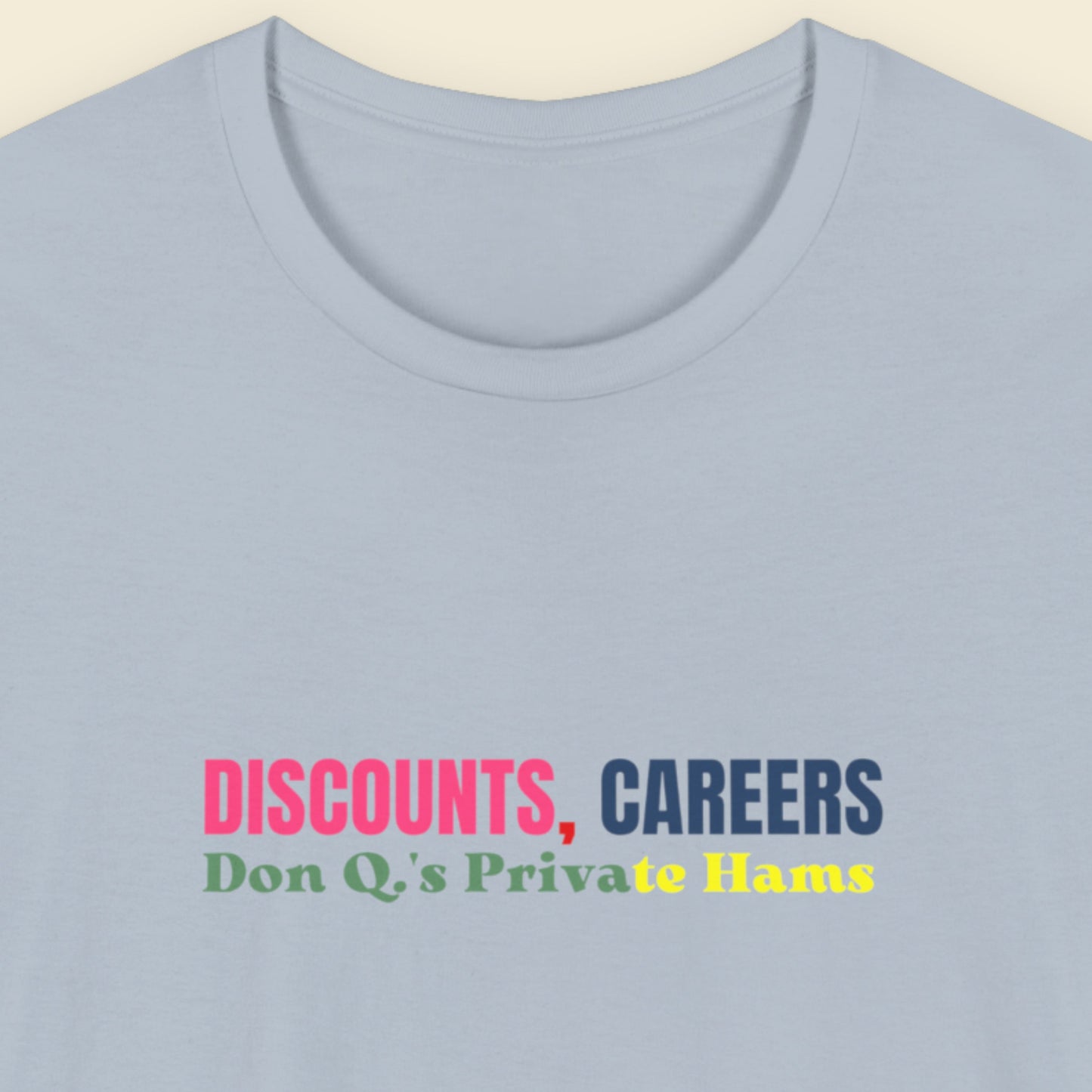 Light blue t-shirt with colorful text on a beige background