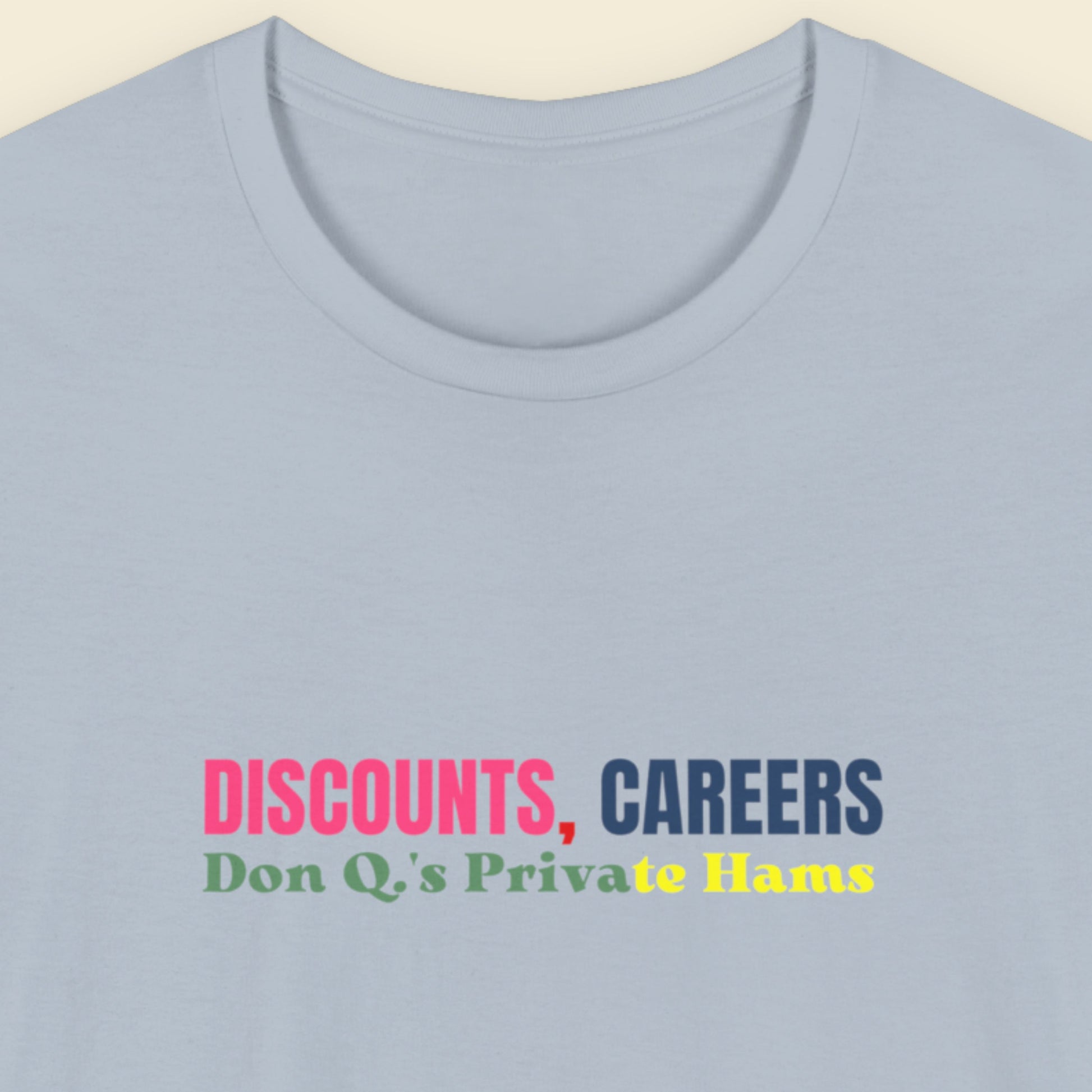 Light blue t-shirt with colorful text on a beige background