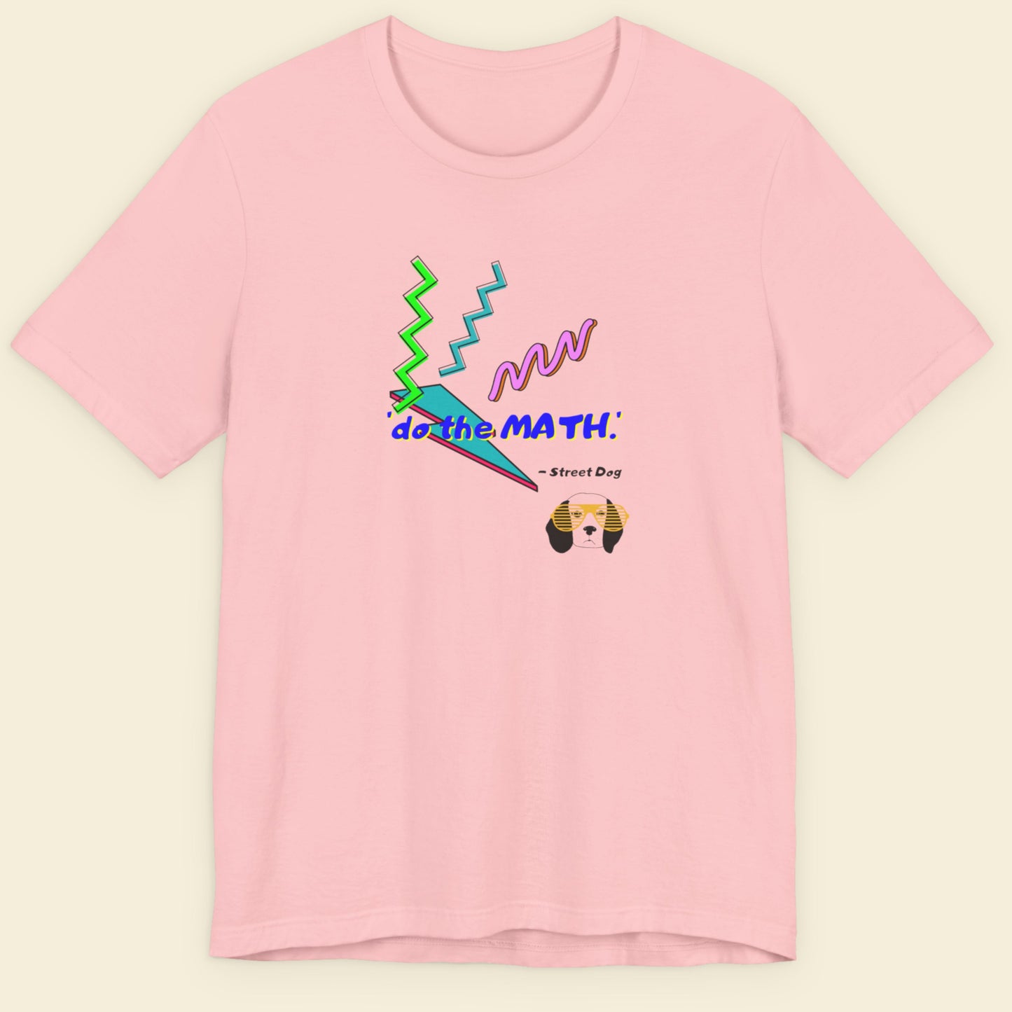 Pink t-shirt with colorful graphics and text on a beige background.
