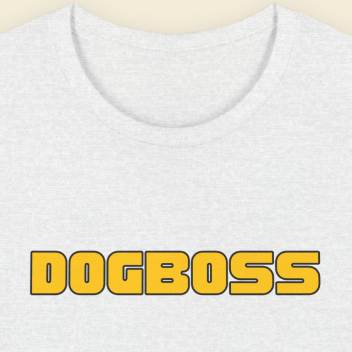 Ash grey t-shirt with humorous colorful text on a beige background.