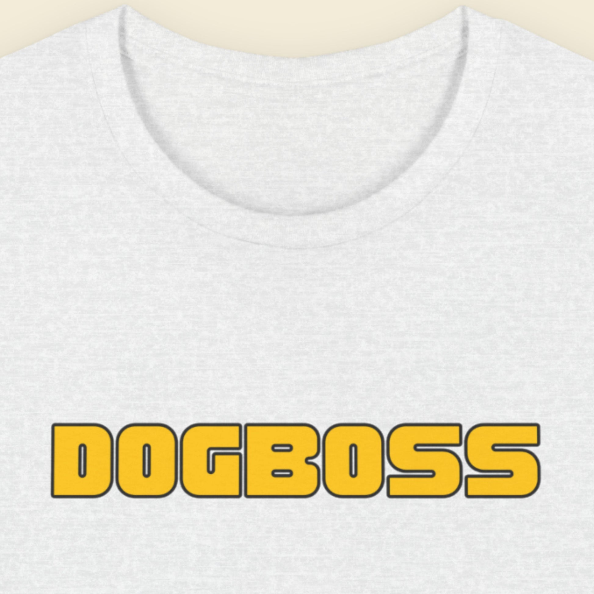 Ash grey t-shirt with humorous colorful text on a beige background.