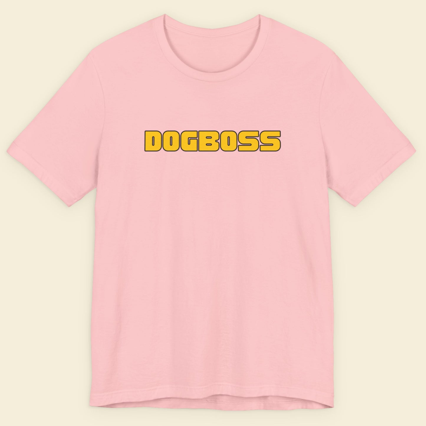 Pink t-shirt with humorous colorful text on a beige background.
