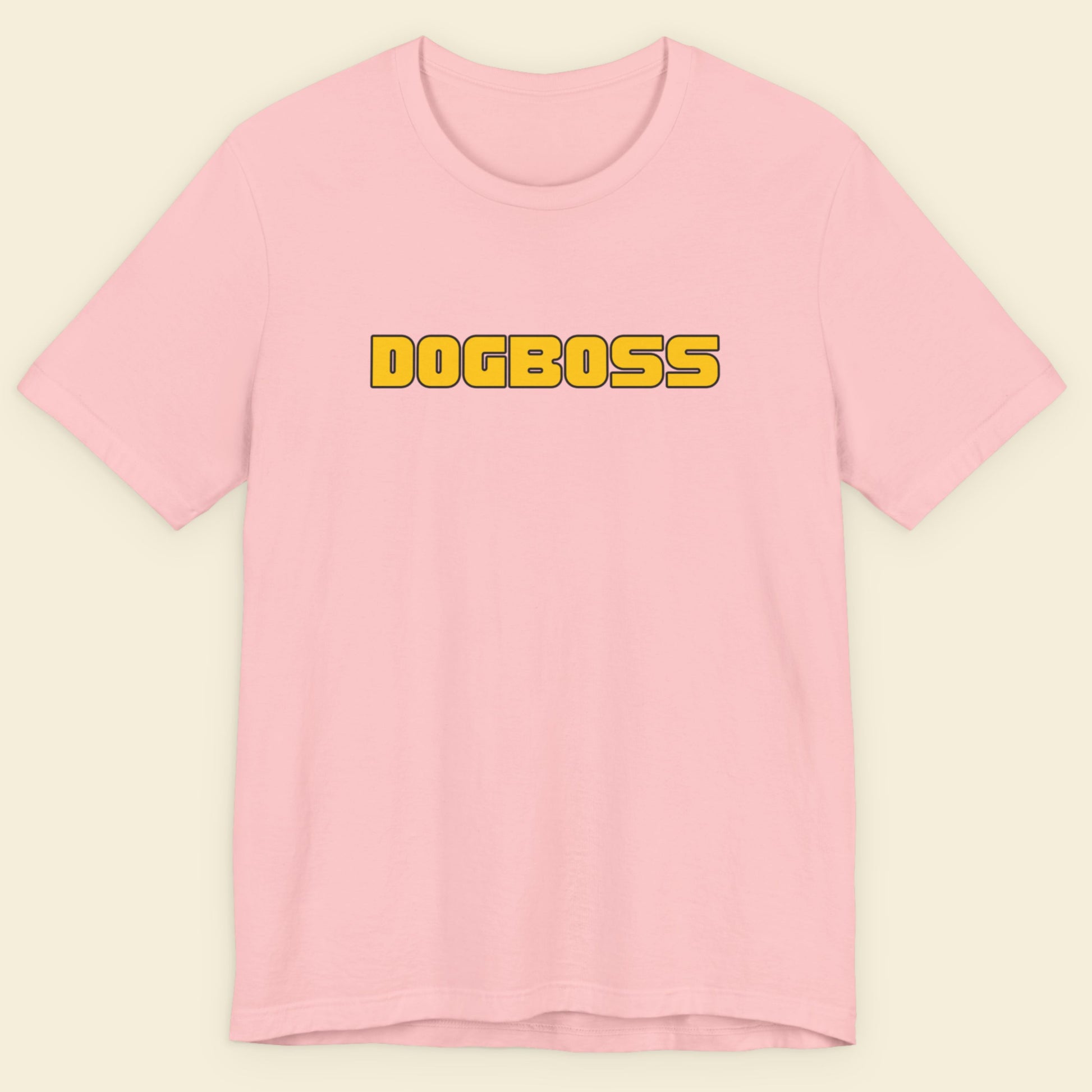 Pink t-shirt with humorous colorful text on a beige background.