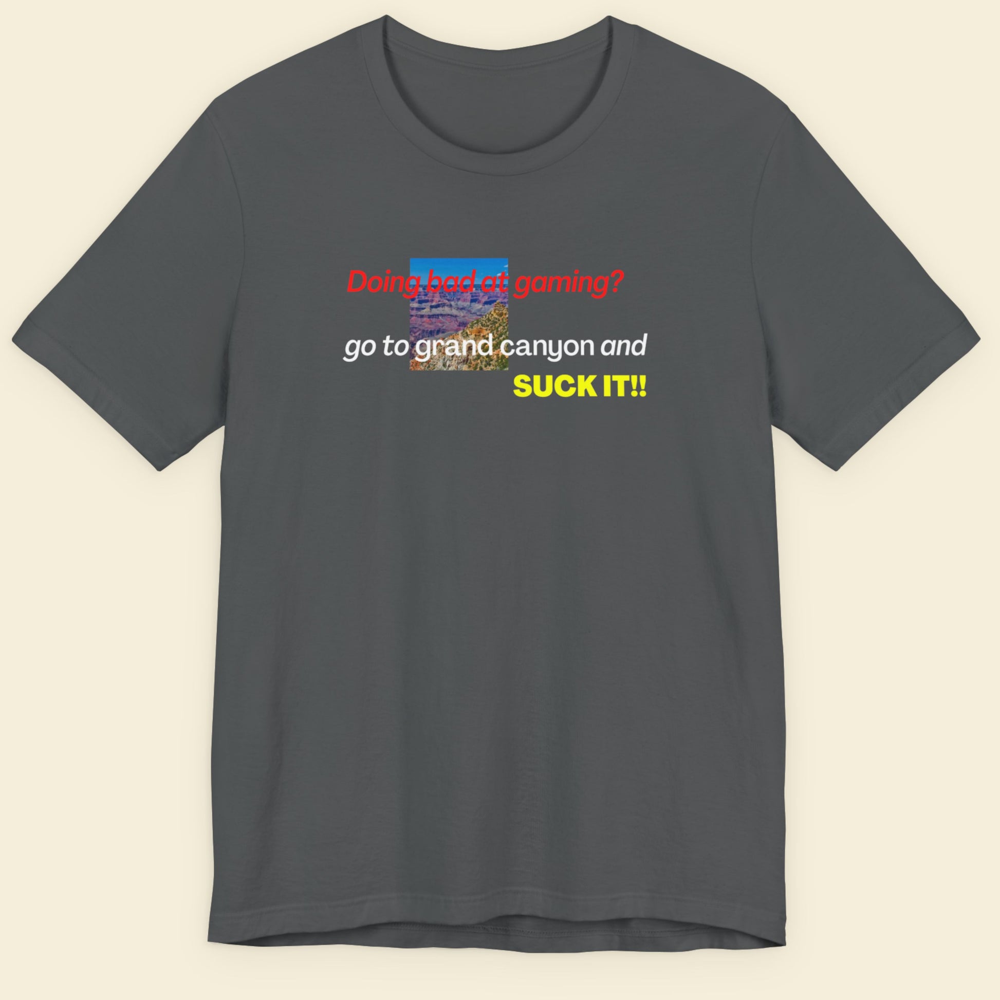 Gray t-shirt with colorful text and graphics on a beige background.