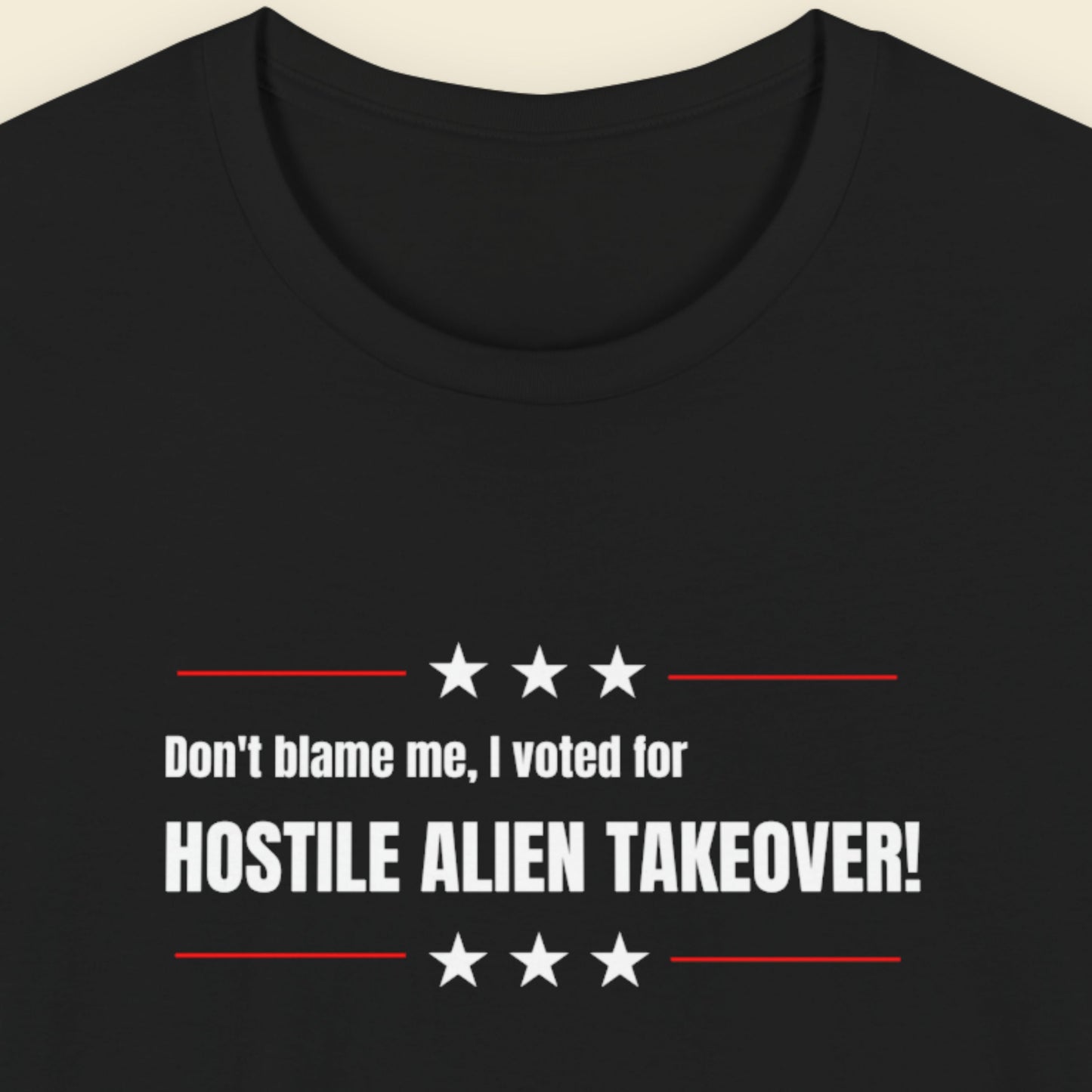 Black t-shirt with humorous colorful text on a beige background.
