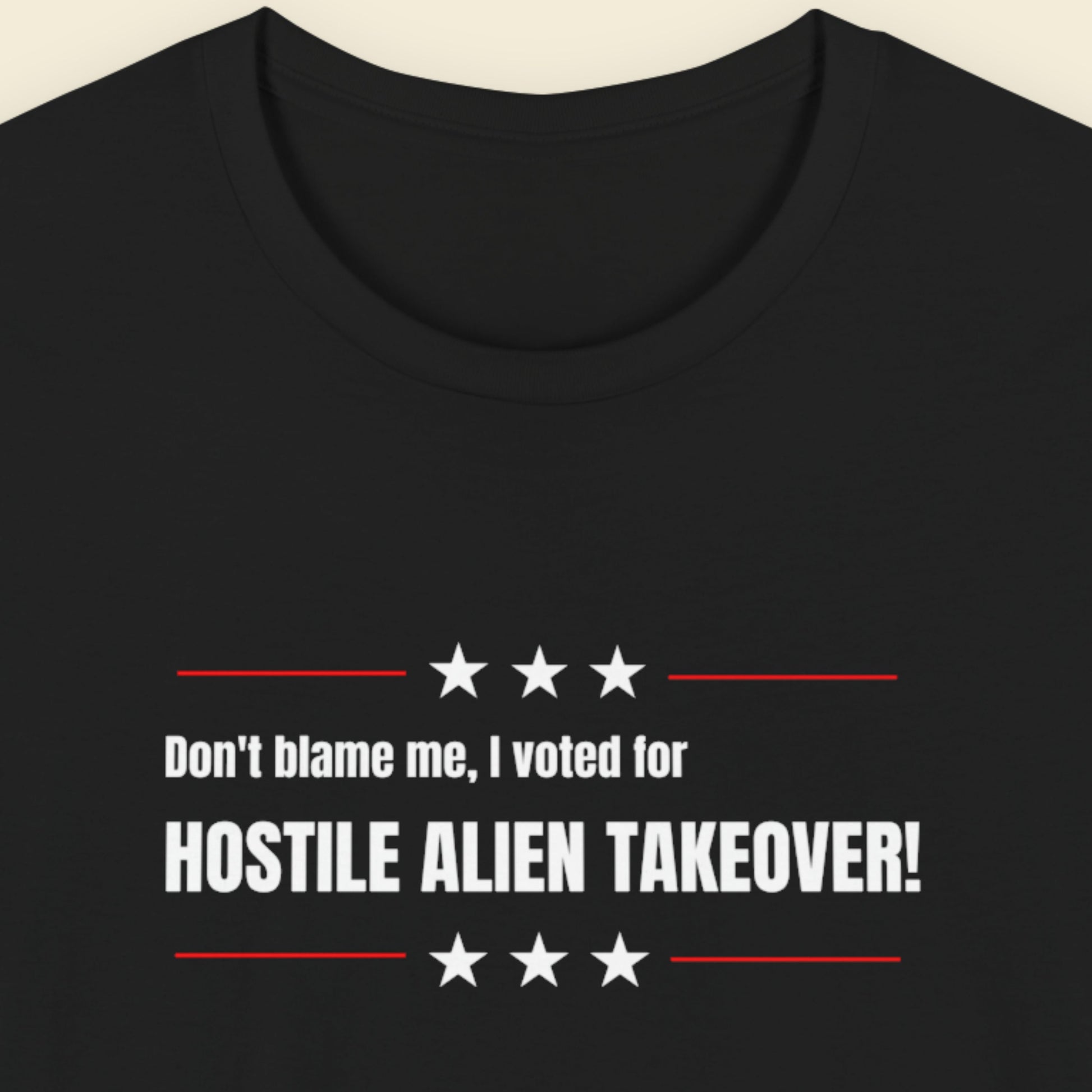 Black t-shirt with humorous colorful text on a beige background.