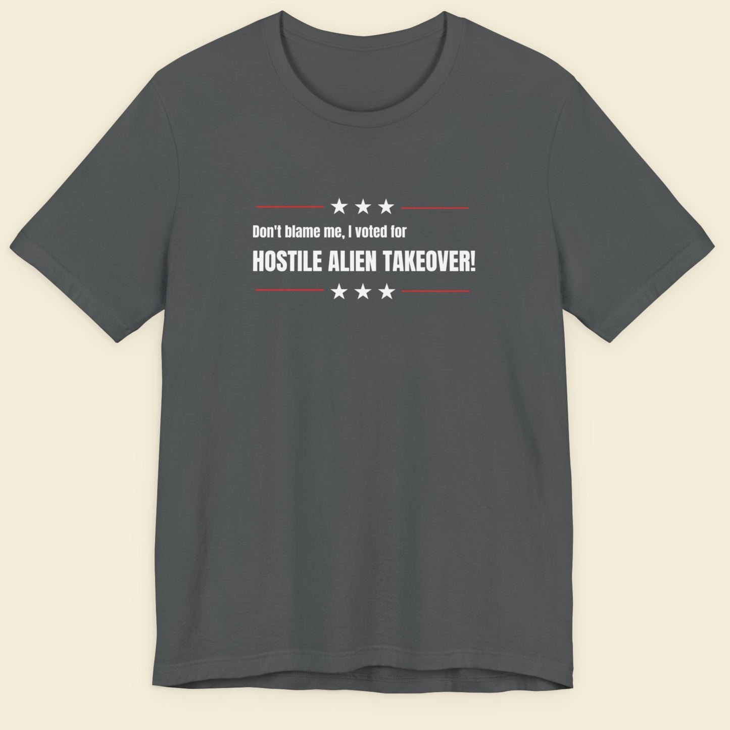Gray t-shirt with humorous text design on a beige background.